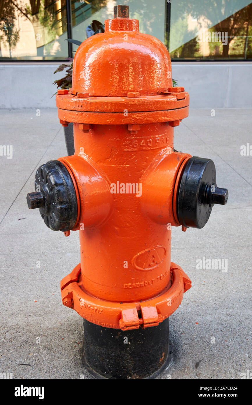 orange painted fire hydrant on sidewalk louisville kentucky USA made by