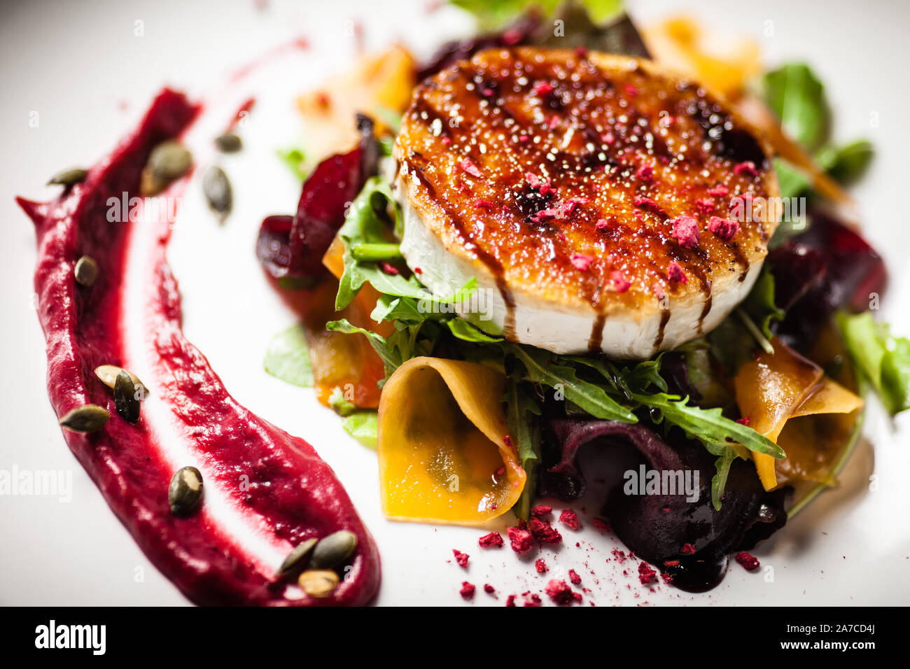 Grilled goat cheese salad served on a plate in restaurant Stock Photo -  Alamy