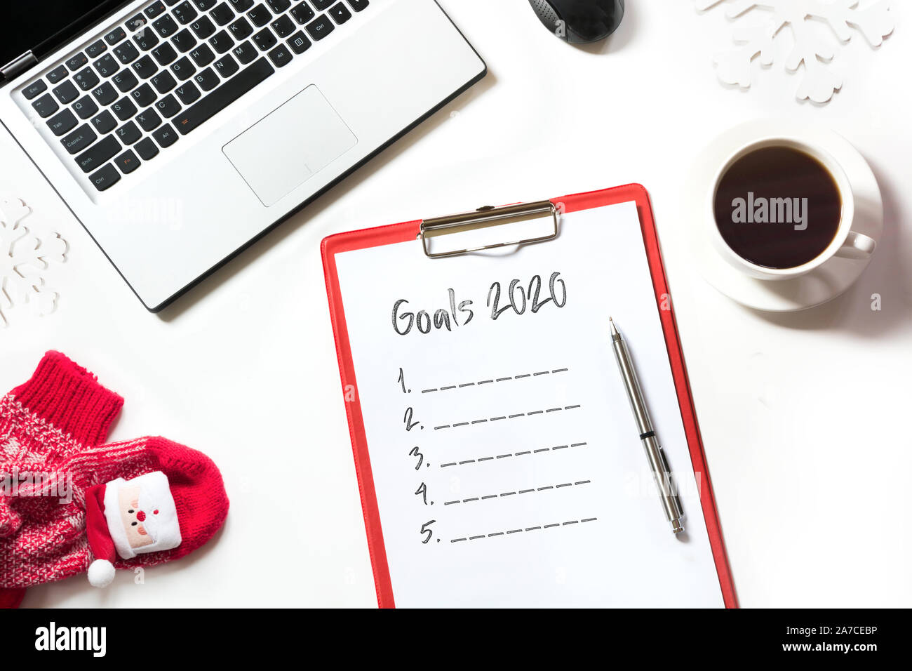 2020 New Year goals, planning, dreams and wishes. Office workplace with laptop, fir branches on white background. Top view with copy space. Stock Photo