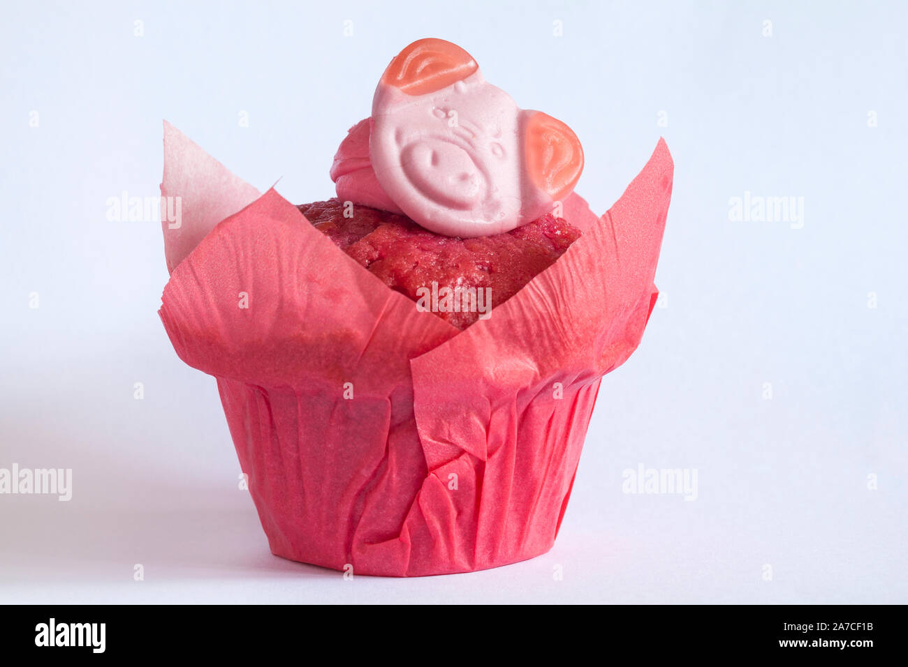Percy Pig heart sweet muffin fresh from M&S in-store bakery isolated on white background Stock Photo