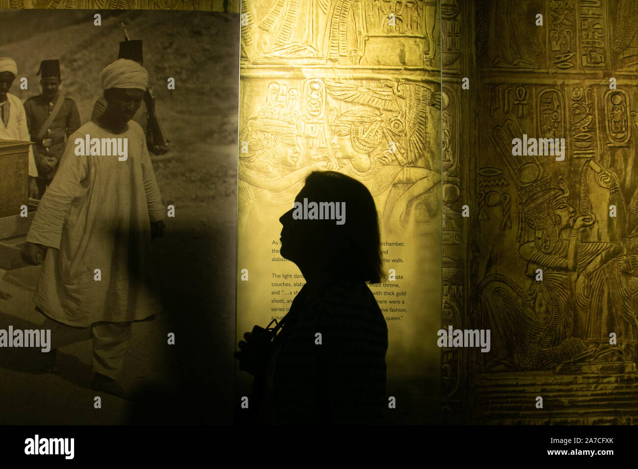 Saatchi Gallery London, UK. 1 November 2019. A visitor at the preview  featuring the largest collection of 60 of   treasures  and original artifacts from Tutankhamun's tomb ever to leave Egypt. The exhibition at the Saatchi Gallery will run from 2 November until 3 May 2020 Stock Photo