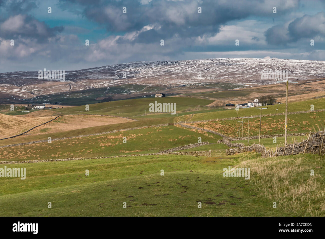 Patches on snow of the higher fells above the remote farming community of Harwood, Upper Teesdale Stock Photo