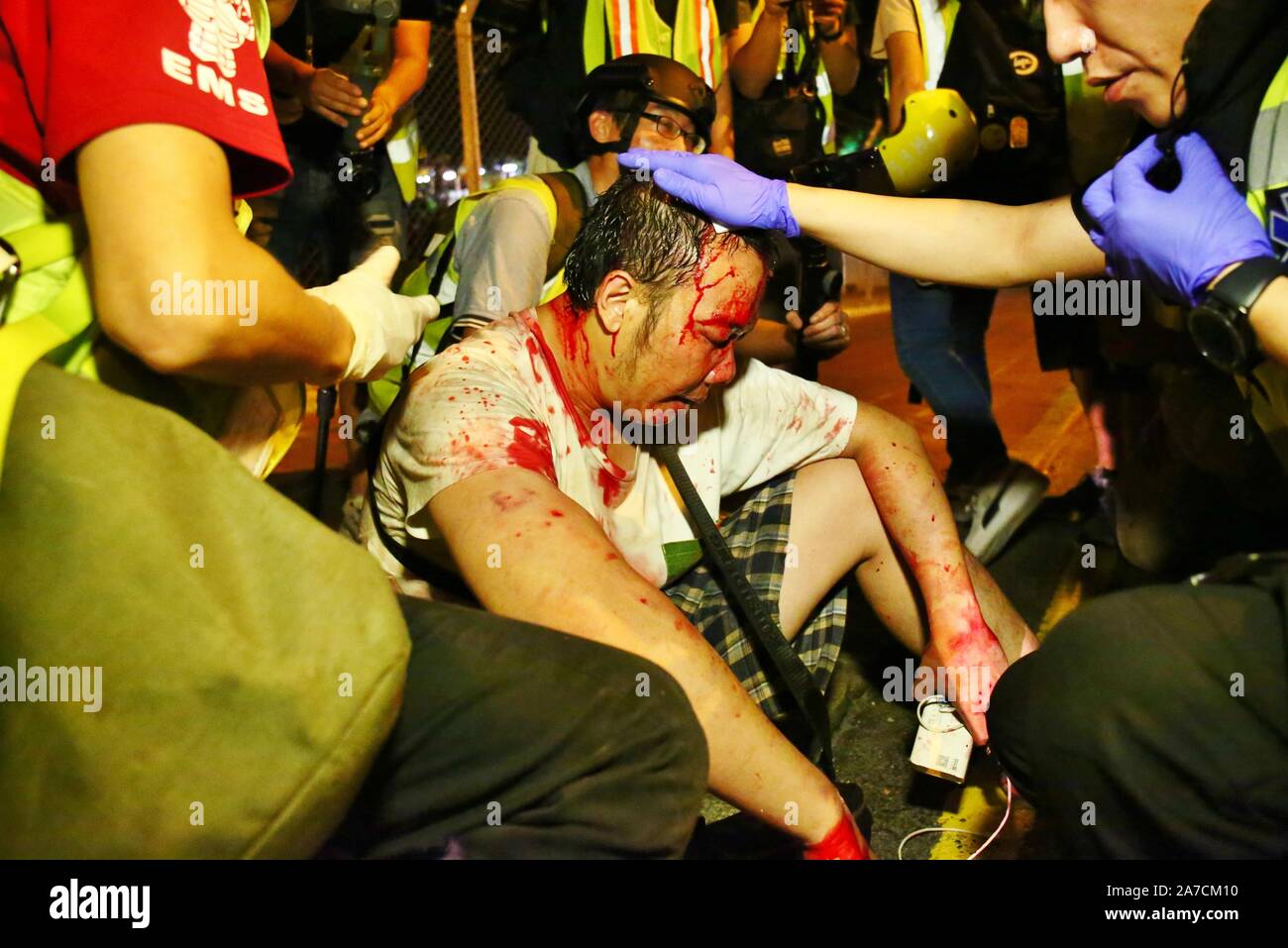 Hong Kong, China. 1st Nov, 2019. Thousands of people wearing masks and costumes marched through Hong Kong's city centre on Halloween night and ended up in the district of Lan Kwai Fong in Central. After midnight clashes broke out and police fired tear gas to clear the streets. Here a driver is attacked by protesters when he tries to drive through the road blocks and hits the crowds. Credit: Gonzales Photo/Alamy Live News Stock Photo