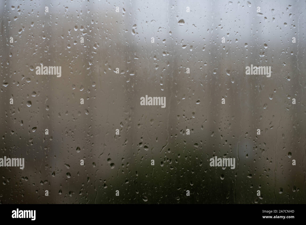 Imprisoned by rain, steam cover window with rain drops and out of focus ...