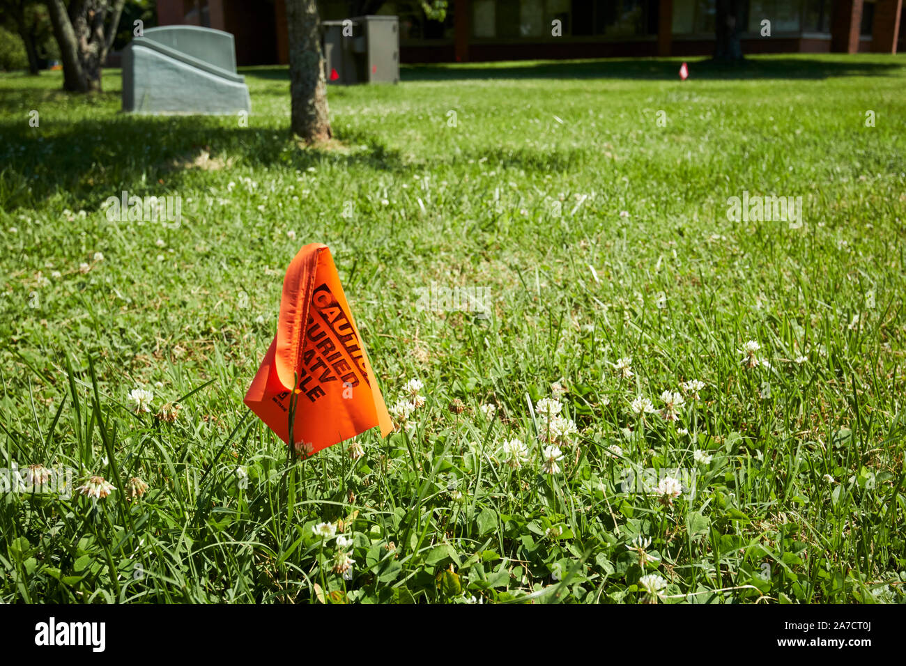 orange flag marker above buried catv cable in ground berea kentucky USA Stock Photo