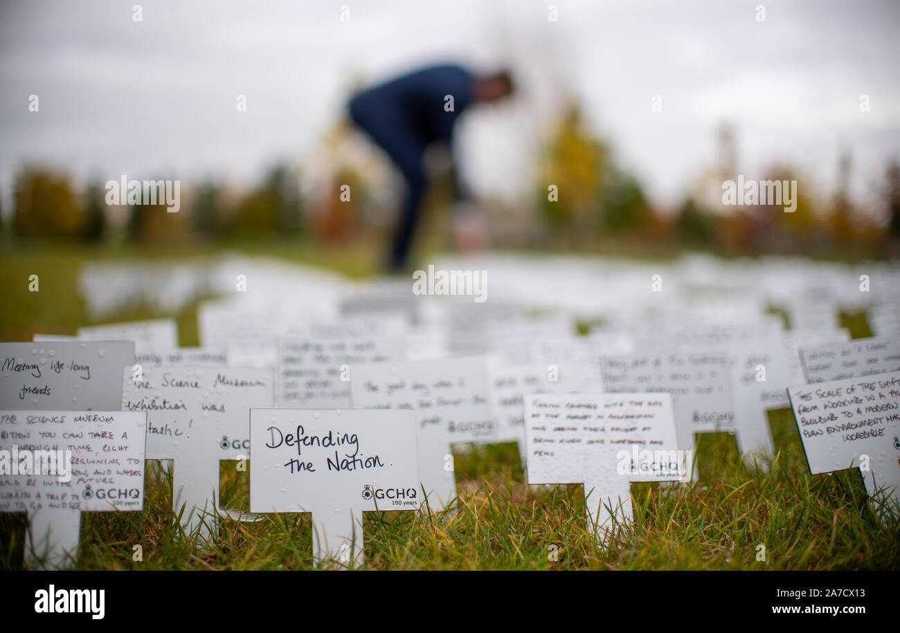 Staff members add their personal messages to a commemorative display at an event to mark 100 years of the Government Communications Headquarters (GCHQ), at the National Memorial Arboretum in Alrewas, Staffordshire. Stock Photo