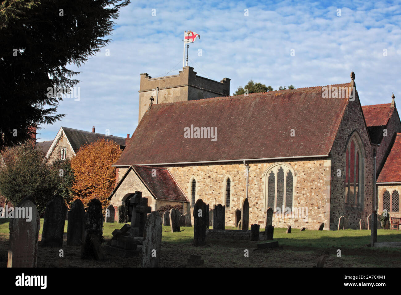 Exterior of St. Mary's Church across the churchyard, showing the squat, sturdy Norman tower: Selborne, Hampshire Stock Photo