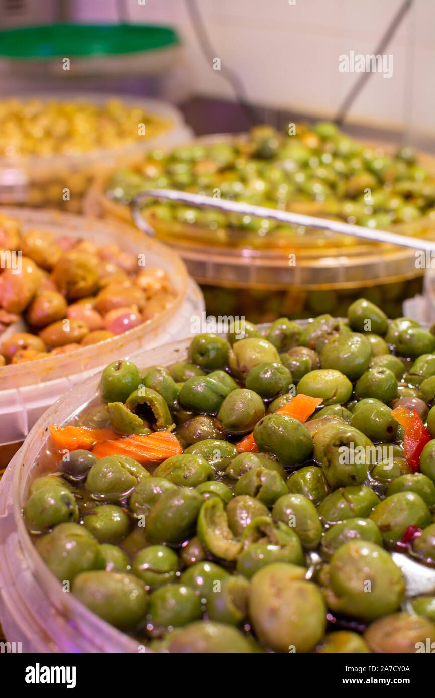 Homemade pickled green olives with garlic and spices in bucket on