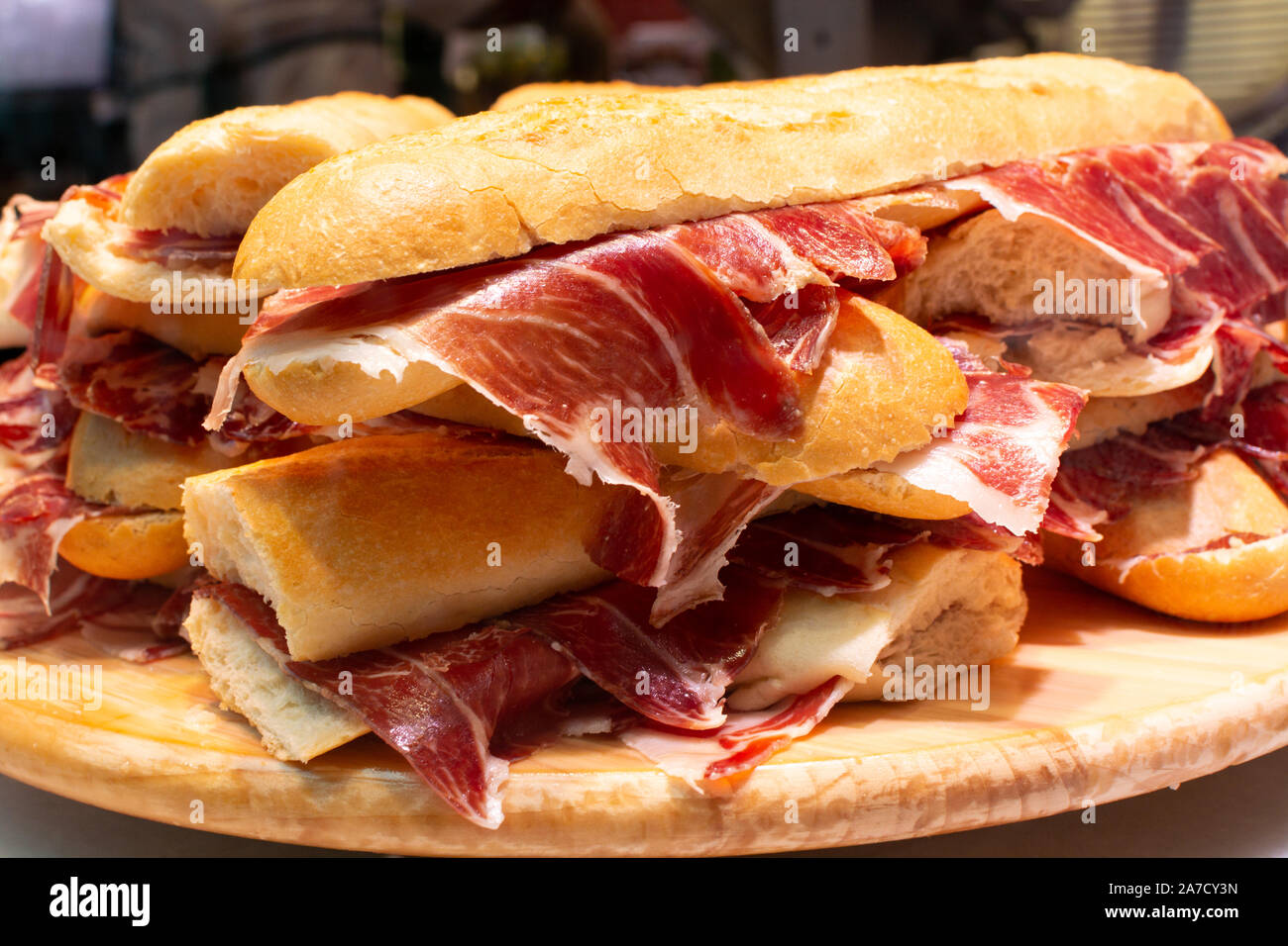 Spanish tapas street food, bocadillo fresh bread with jamon iberico
