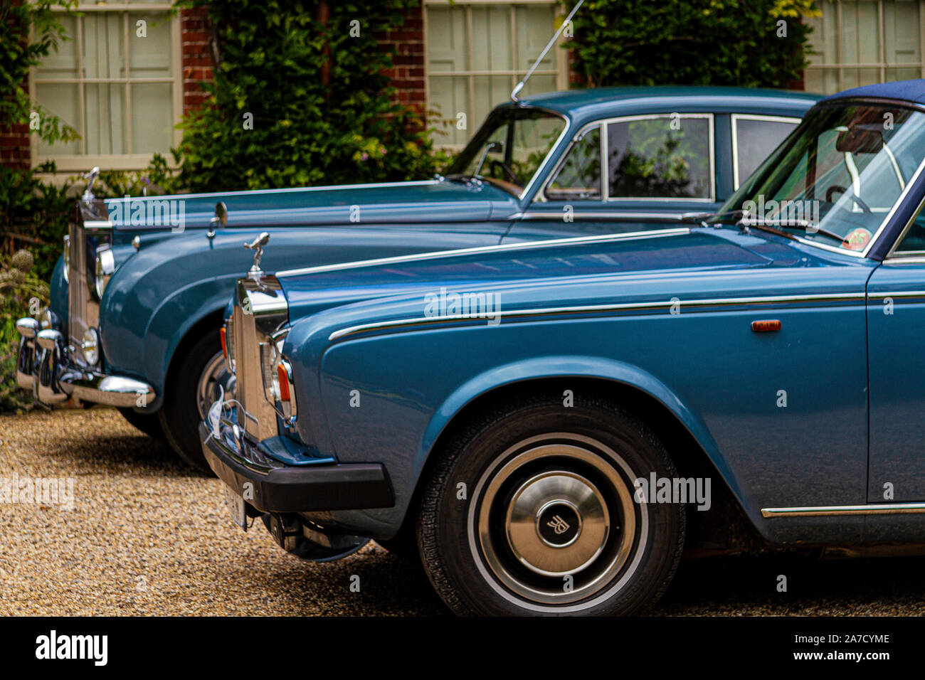 Two Rolls Royce saloons on the forecourt of an ancient mansion house Stock  Photo - Alamy