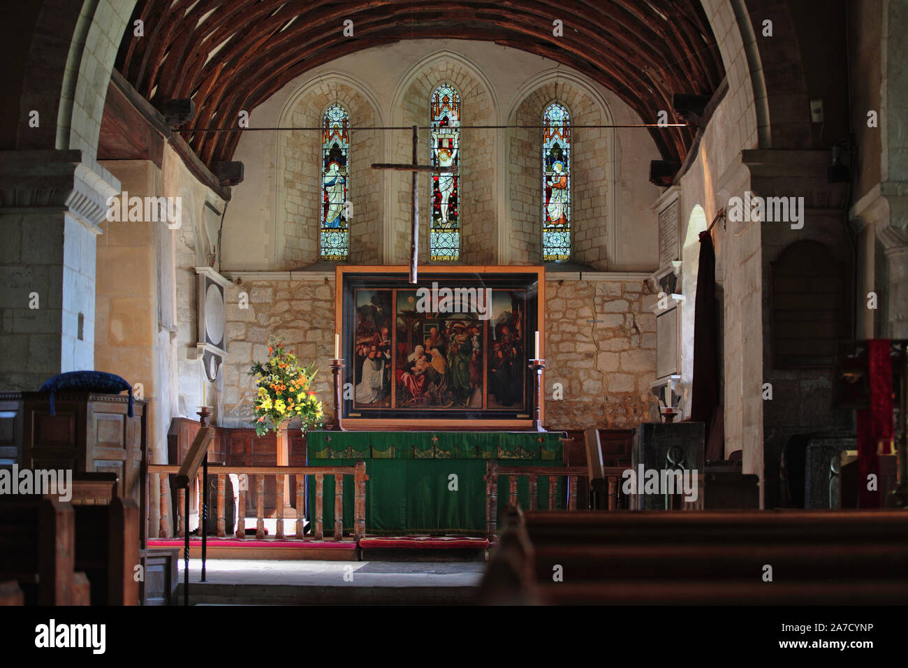 Chancel and altar of St. Mary's Church, Selborne, Hampshire, UK showing a fine triptych painting of the Adoration of the Magi, by Jan Mostaert, 1515 Stock Photo