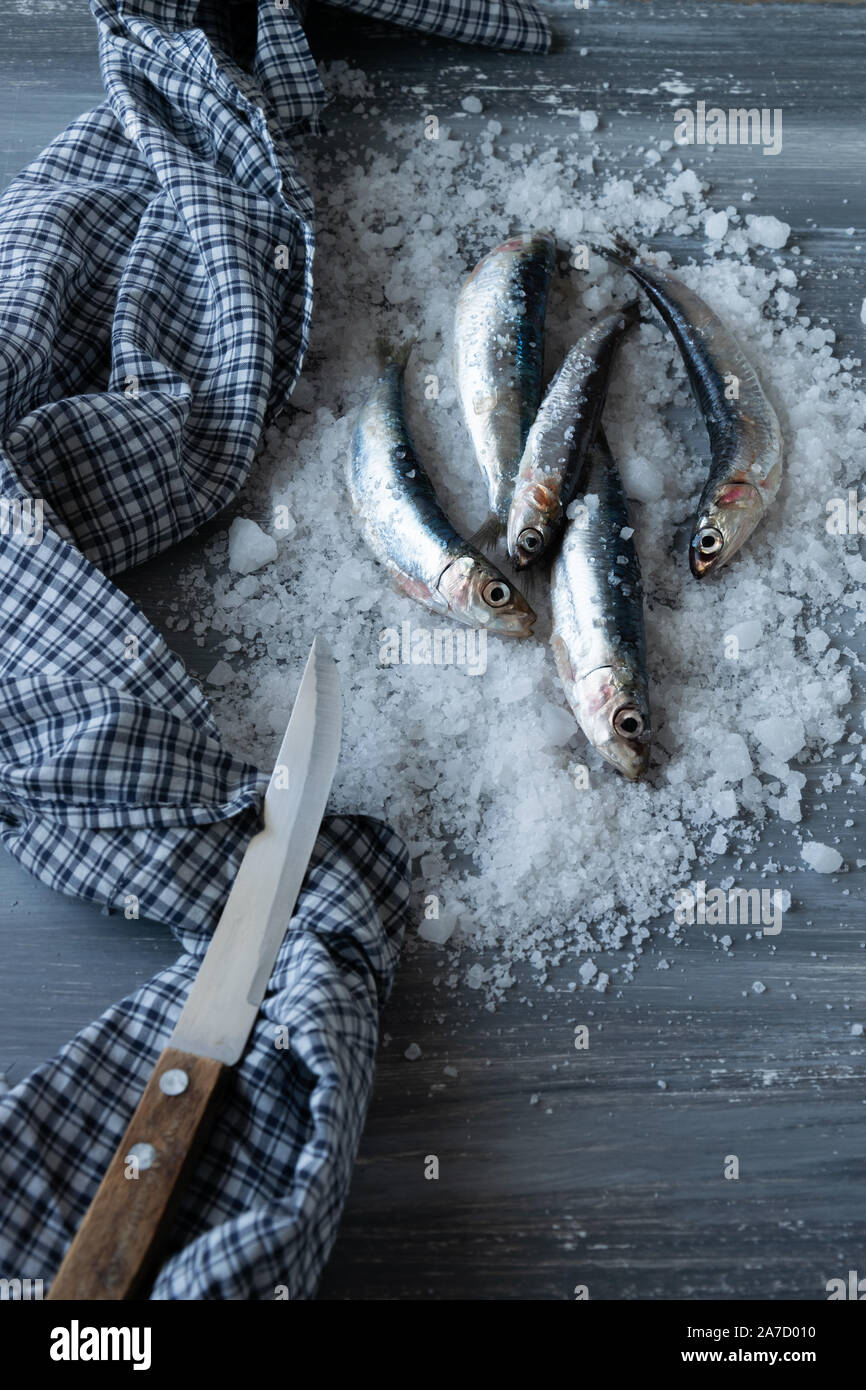 Preparing anchovies in salt. Healthy raw seafood Stock Photo Alamy