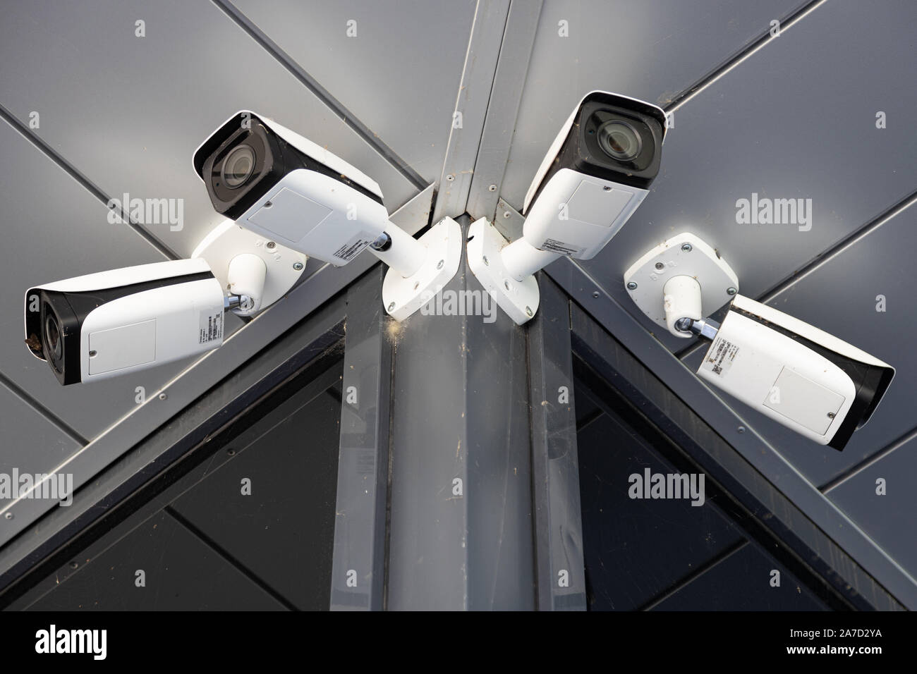 Bottom view closeup of four white surveillance cameras Stock Photo Alamy