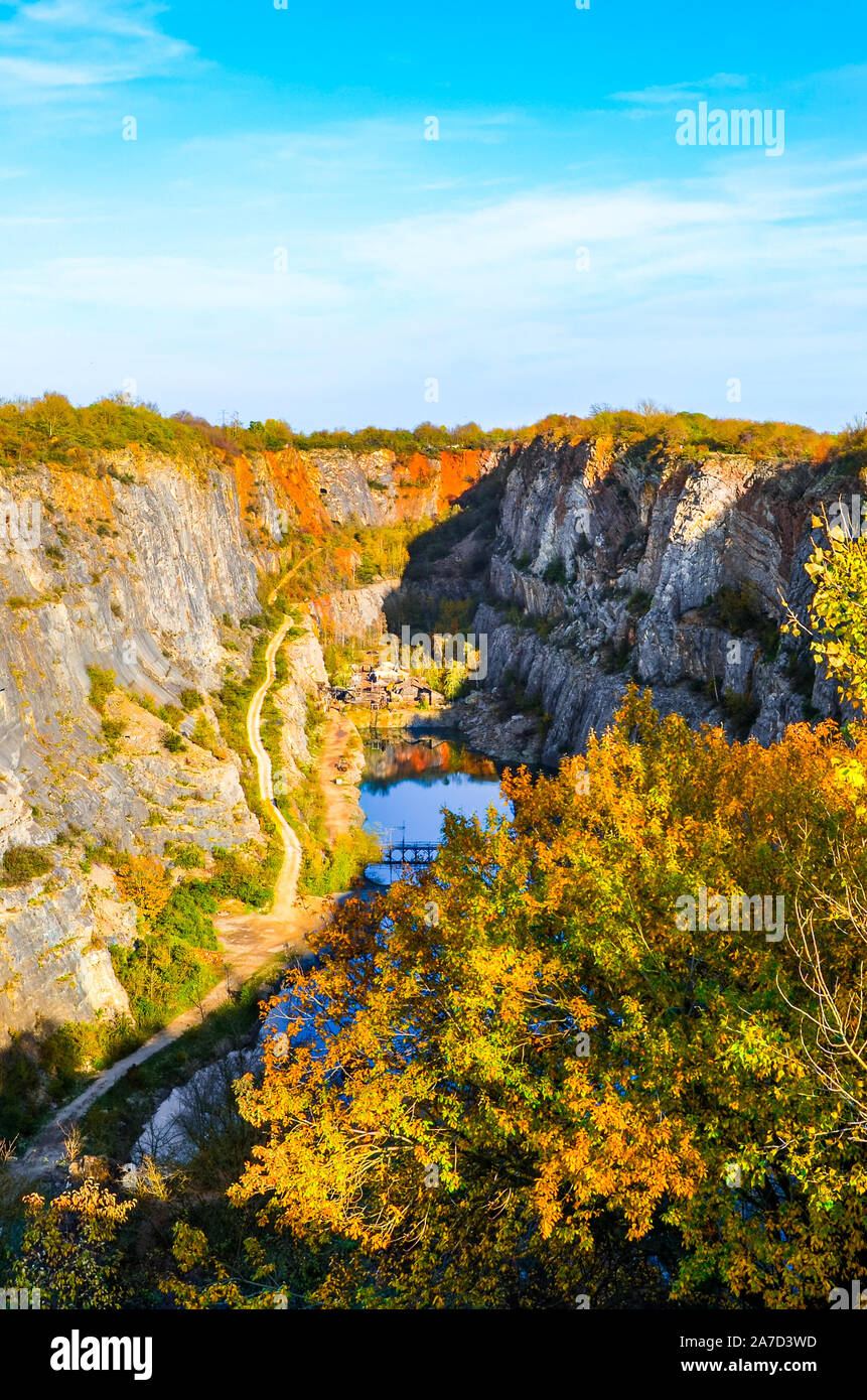 Limestone quarry Velka Amerika in Bohemia, Czechia. Partly flooded quarry surrounded by rocks and trees. Popular tourist attraction and film location. Nature in the Czech Republic. Stock Photo