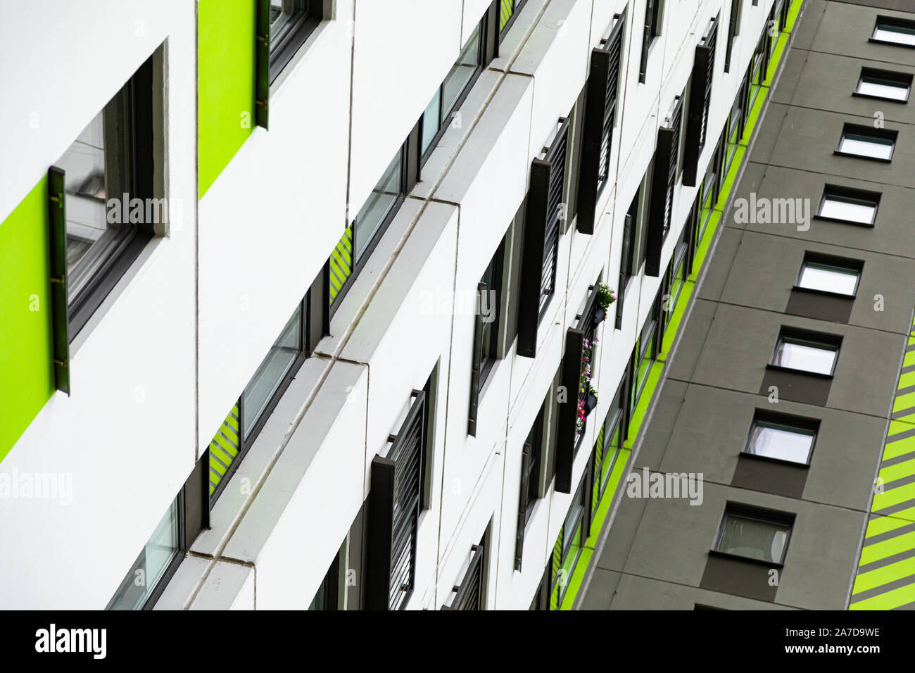 Bottom view of high new multiple dwelling of white, green and grey colors Stock Photo