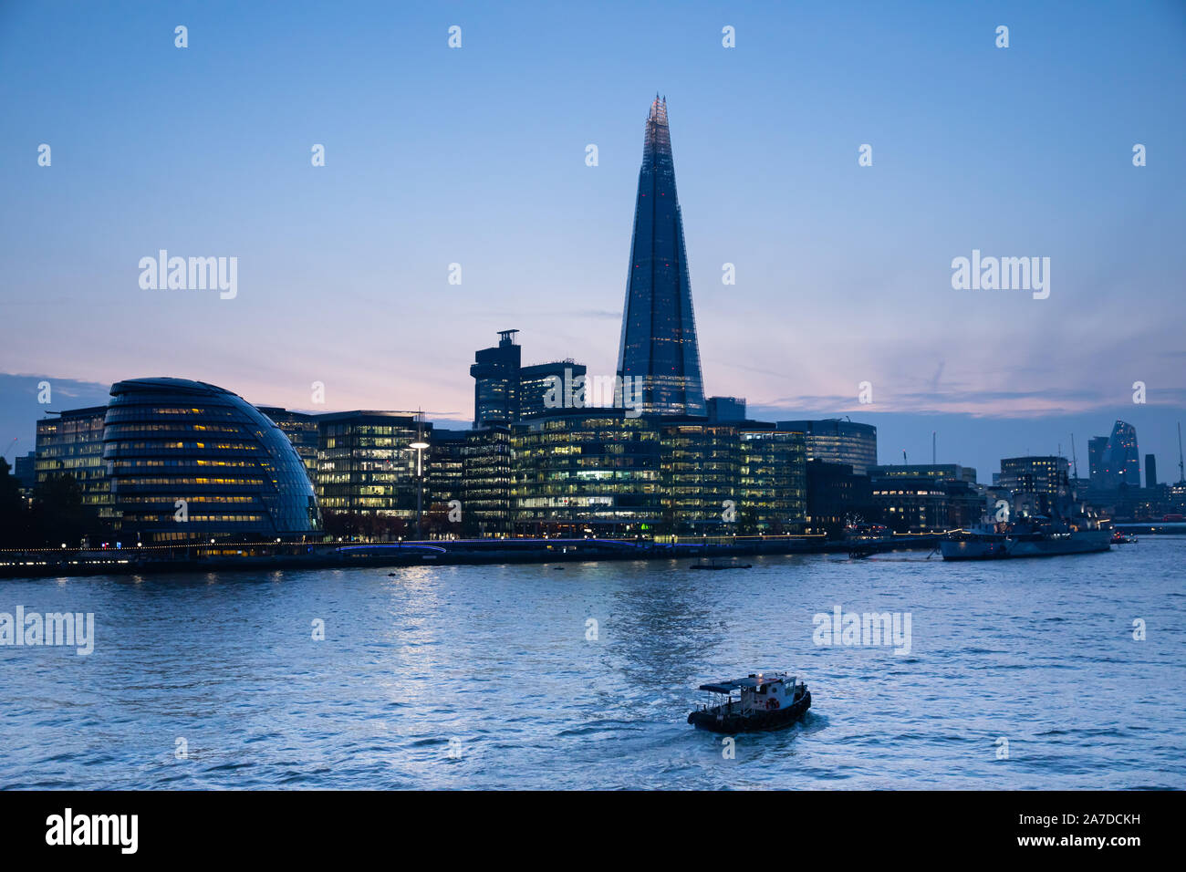 Night time view of London acroos the Thames river showing the Shard and City Hall Stock Photo