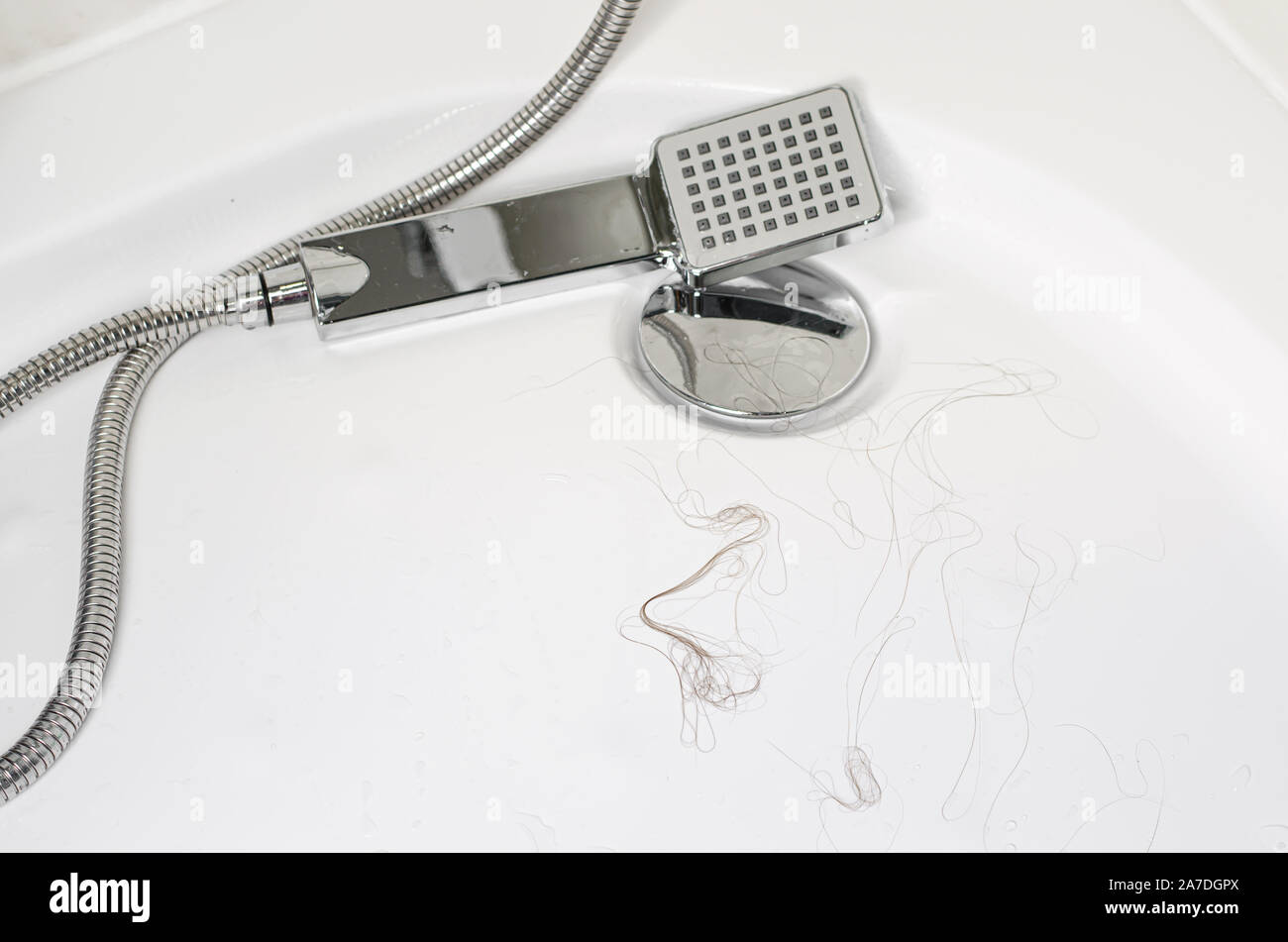 Hair loss after washing hair on the floor in shower. Close up, copy