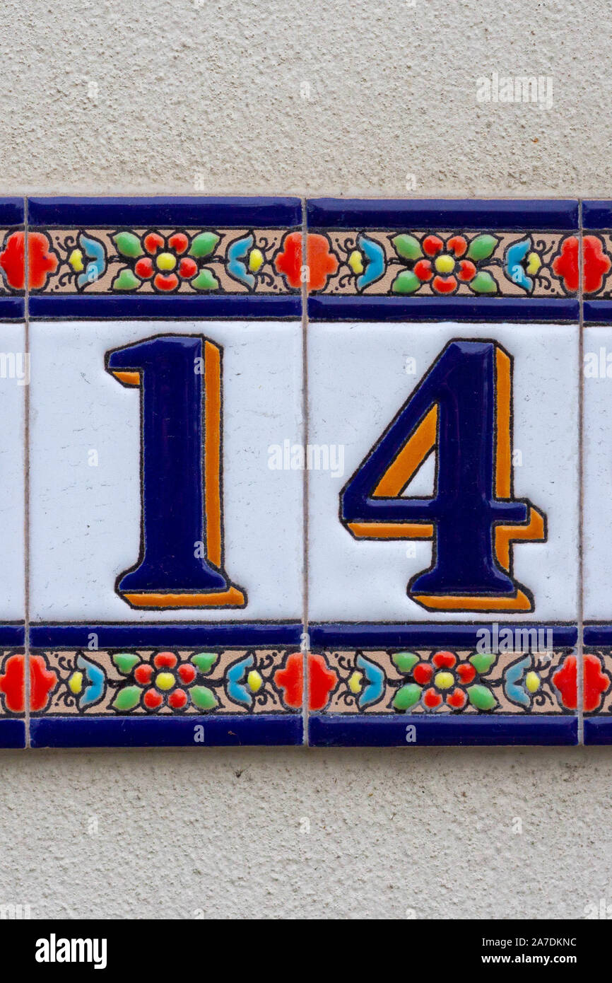 Floral fourteen - house number 14 on ceramic tiles cheerfully decorated Stock Photo