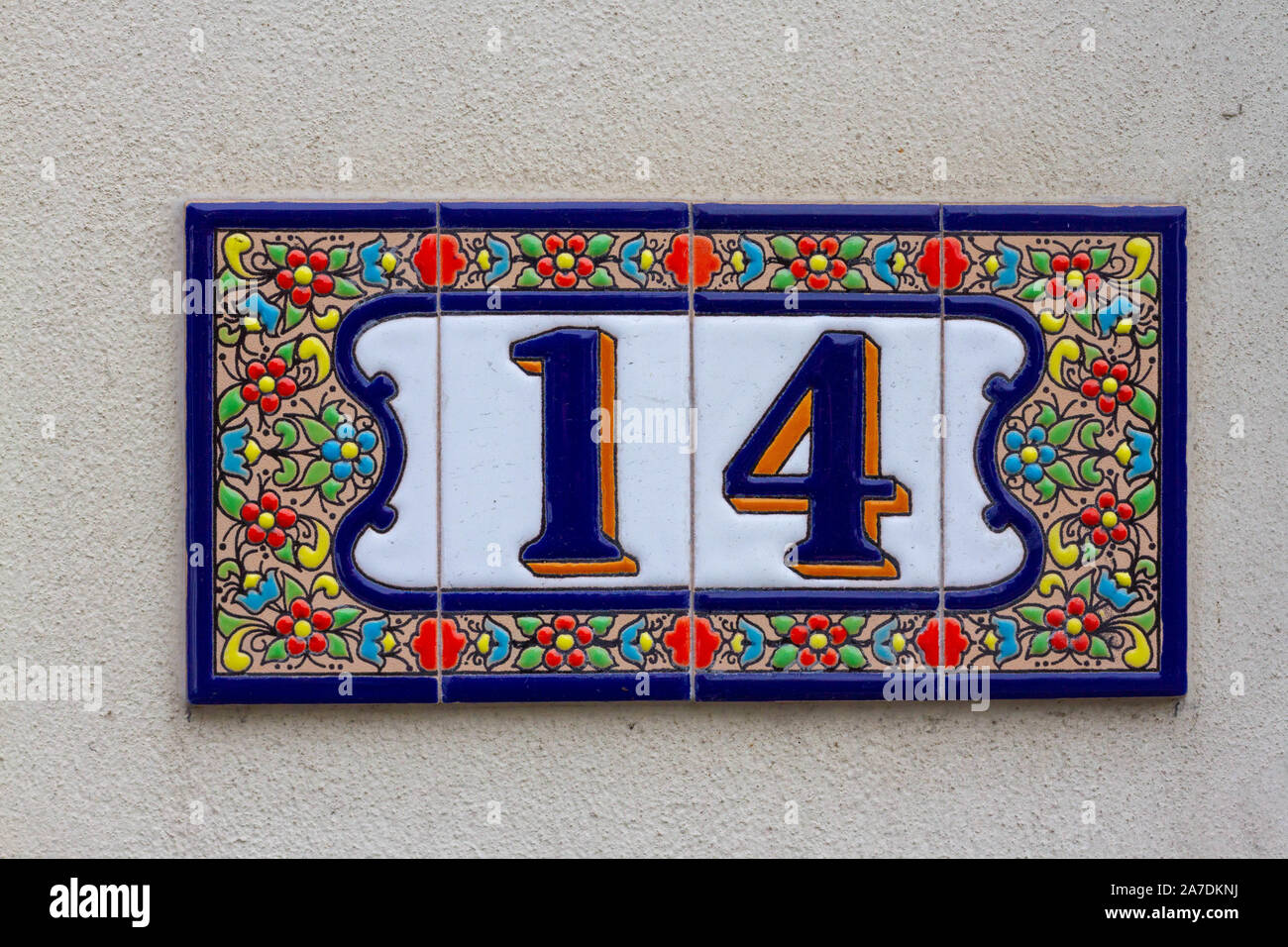 Floral fourteen - house number 14 on ceramic tiles cheerfully decorated Stock Photo