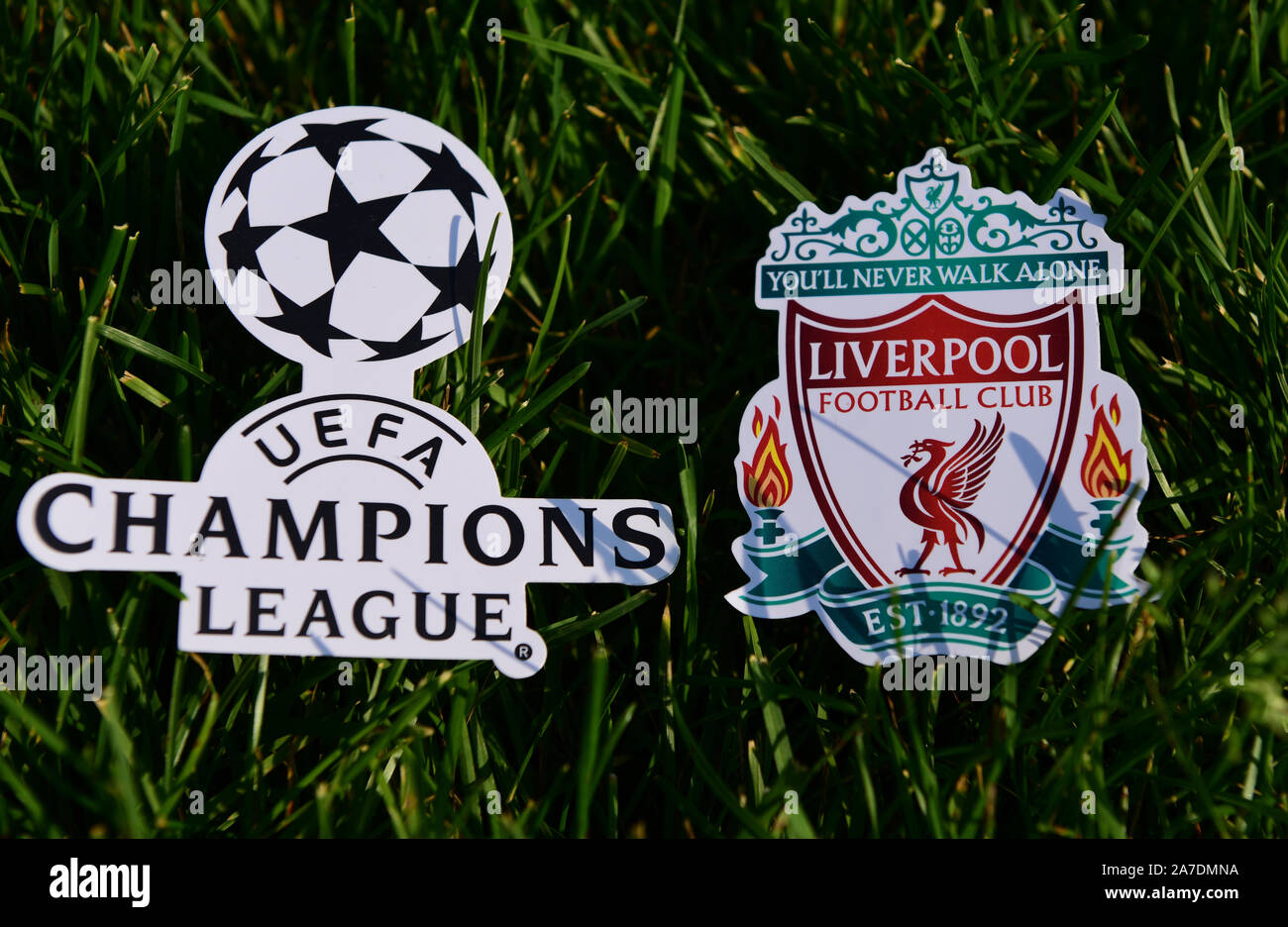 September 6, 2019 Istanbul, Turkey. The emblem of the English football club Liverpool next to the logo of the Champions League on the green grass of t Stock Photo