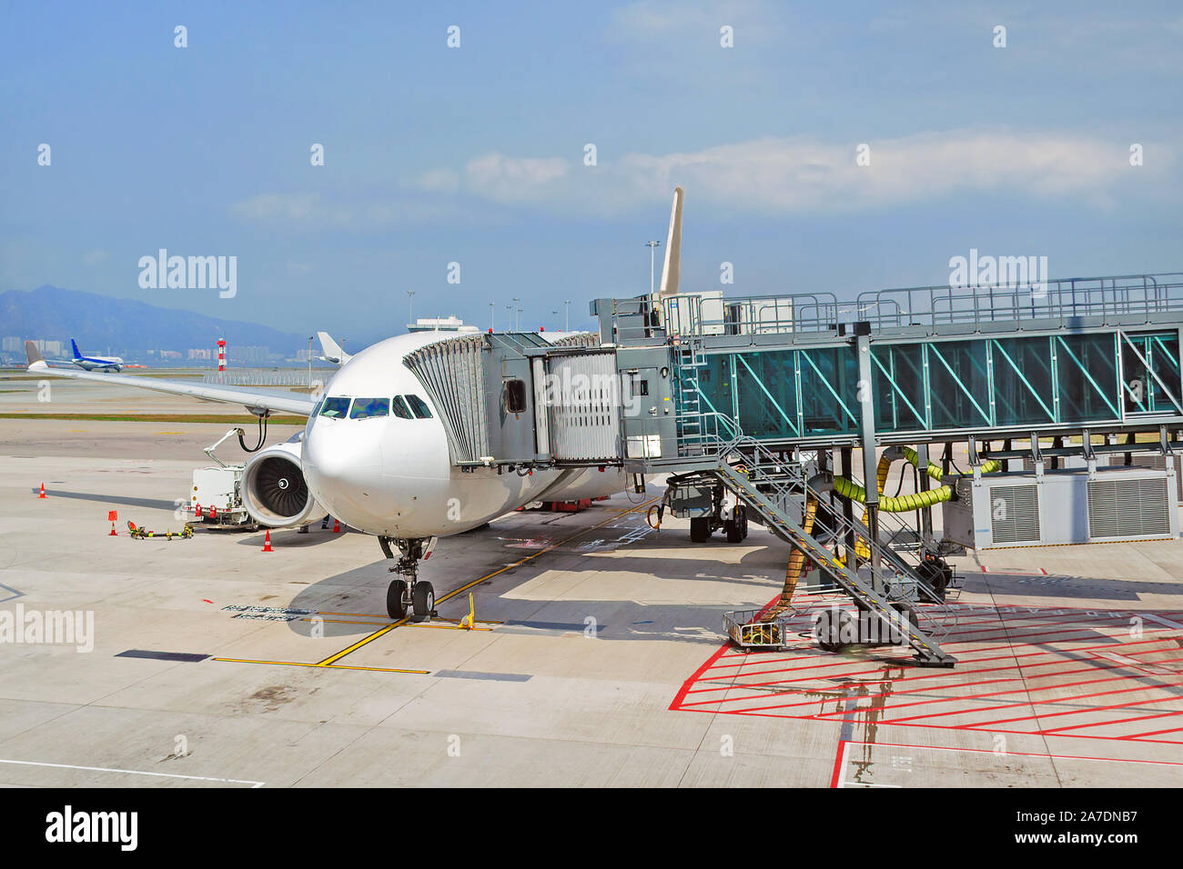 Airport apron with passenger plane and jet bridge for passengers Stock Photo