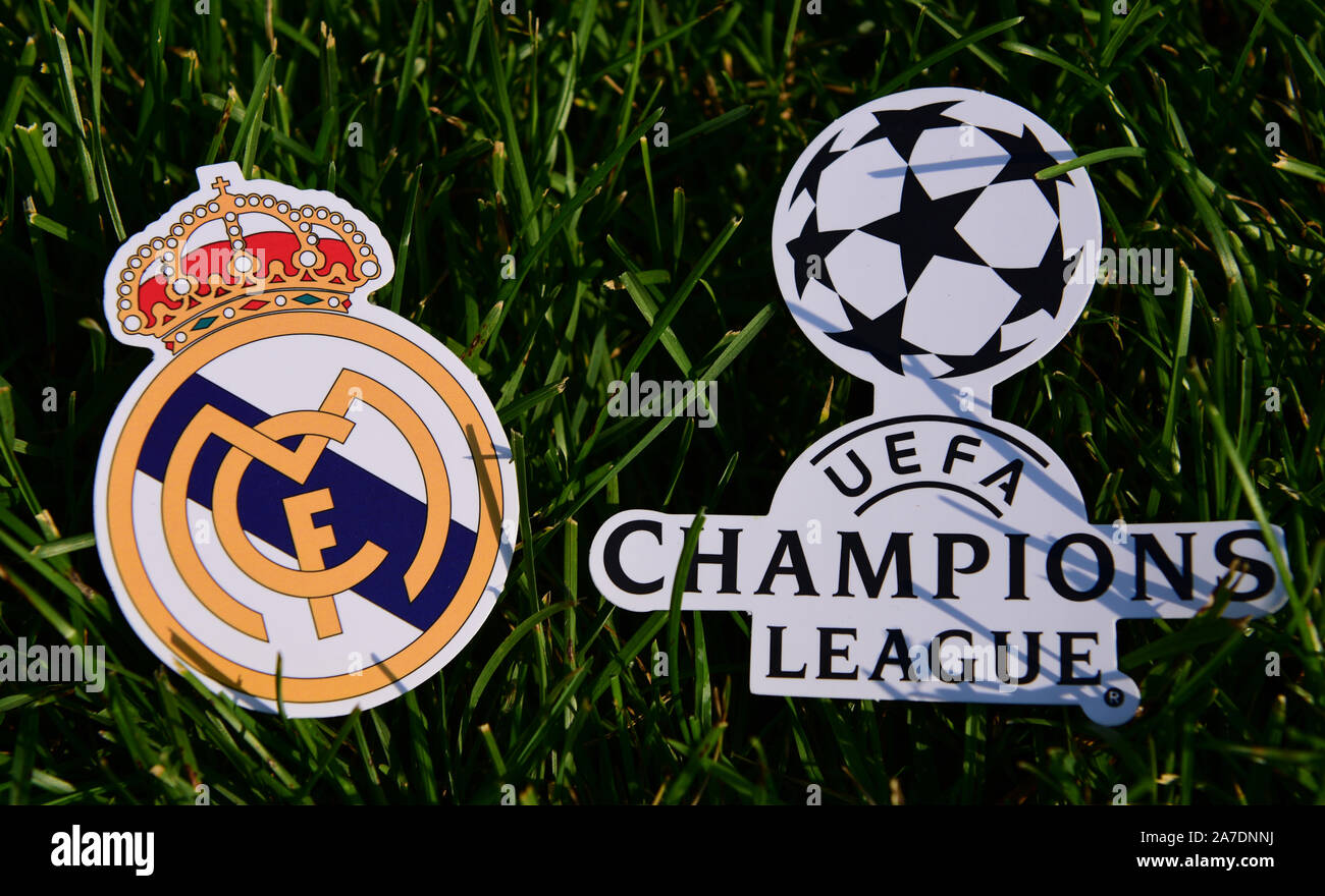 September 6, 2019 Istanbul, Turkey. The emblem of the Spanish football club Real Madrid next to the logo of the Champions League on the green grass of Stock Photo