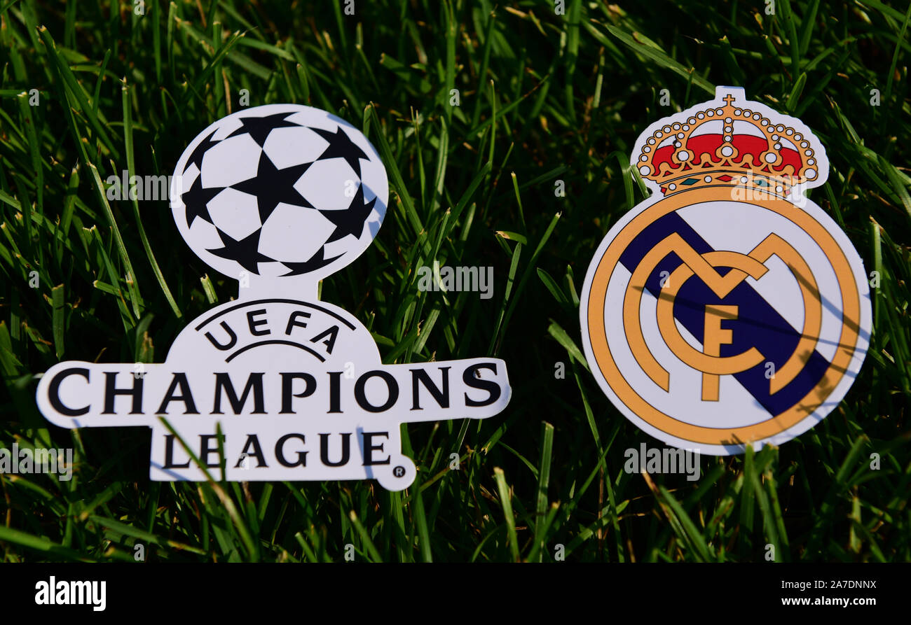 September 6, 2019 Istanbul, Turkey. The emblem of the Spanish football club Real Madrid next to the logo of the Champions League on the green grass of Stock Photo