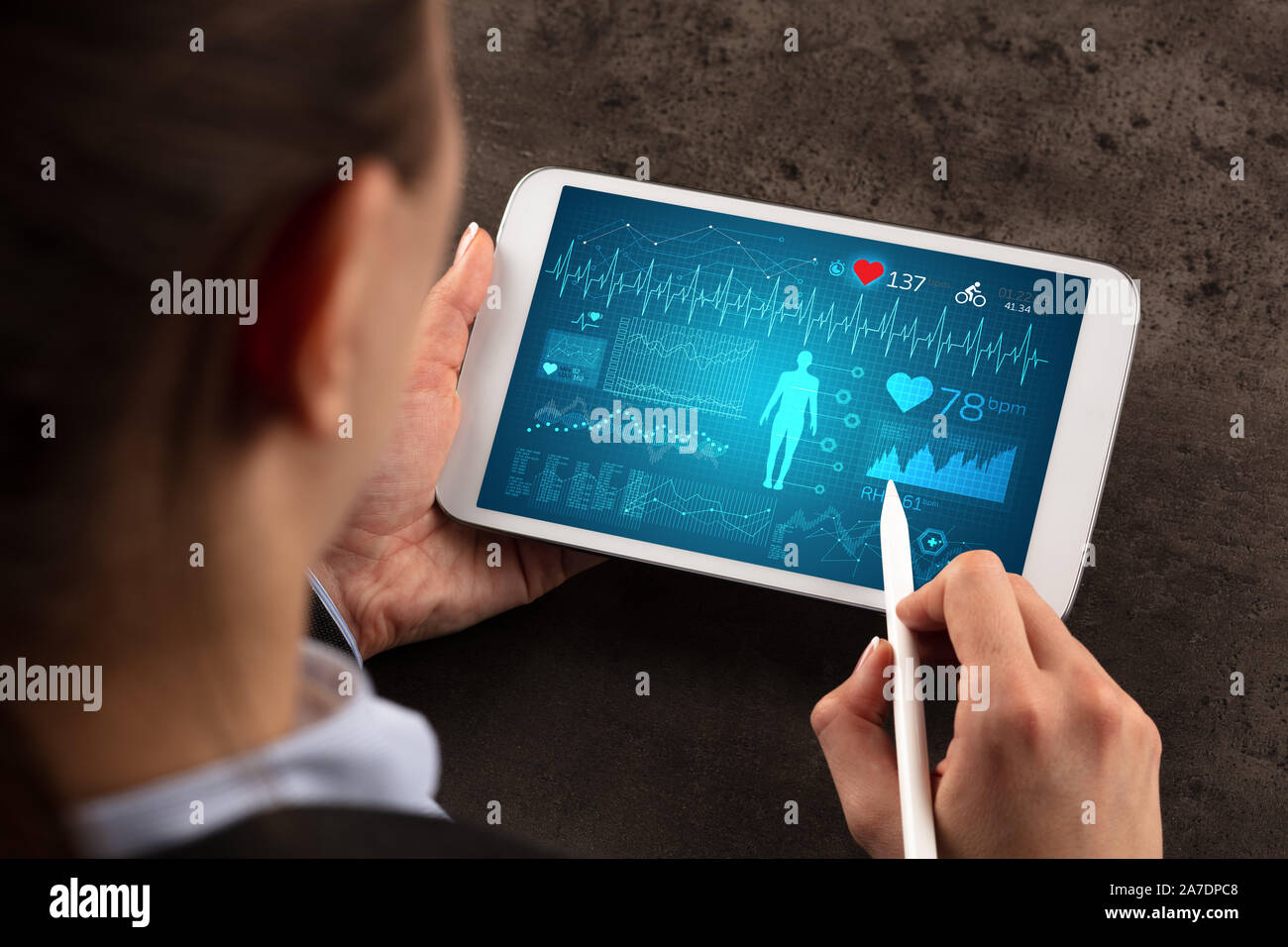 Business woman making healthy analysis on tablet Stock Photo