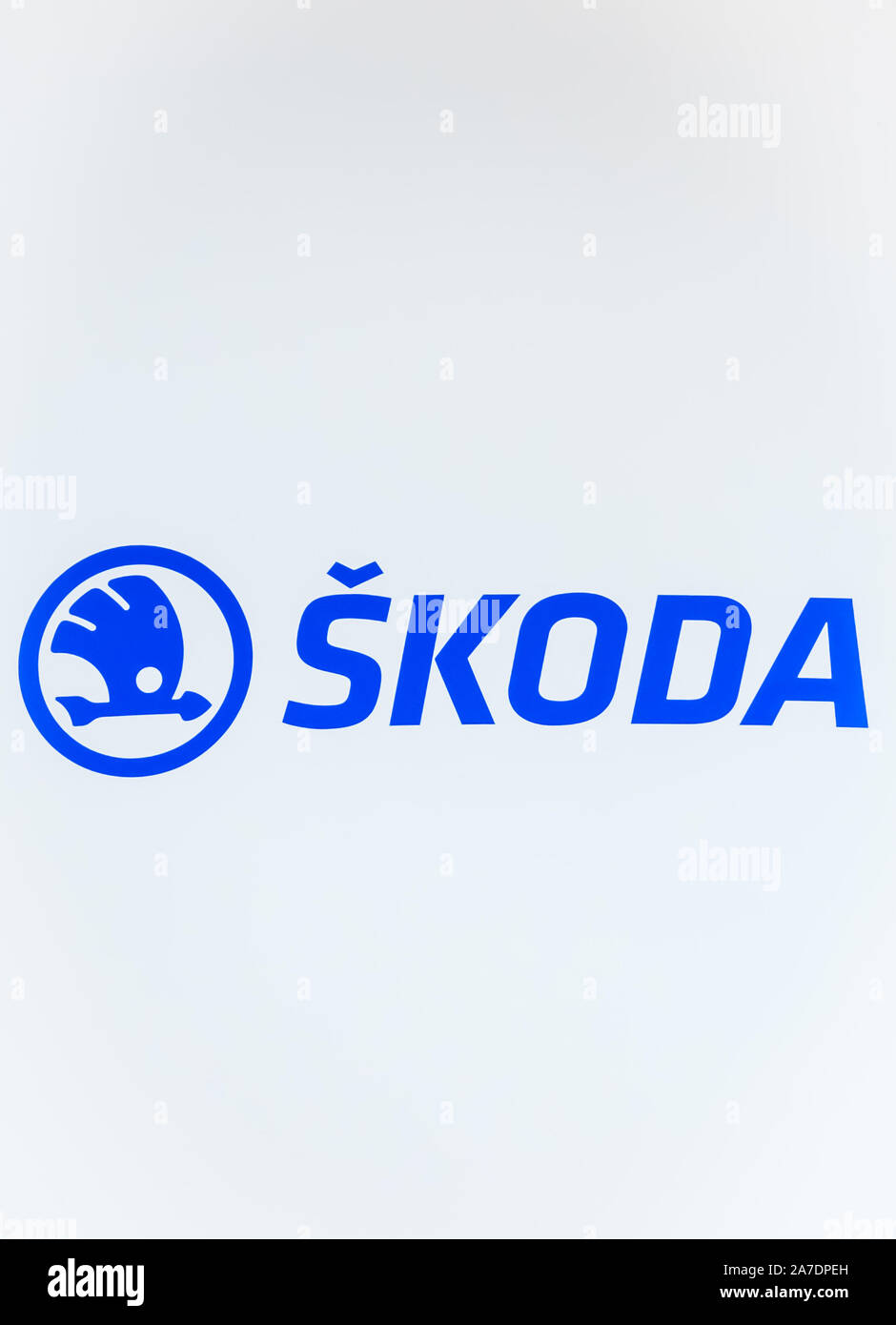 Pilsen, Czechia - Oct 28, 2019: The original blue logo of Skoda photographed with a white wall background. Skoda is car manufacturer from the Czech Republic. The company produces busses or turbines. Stock Photo