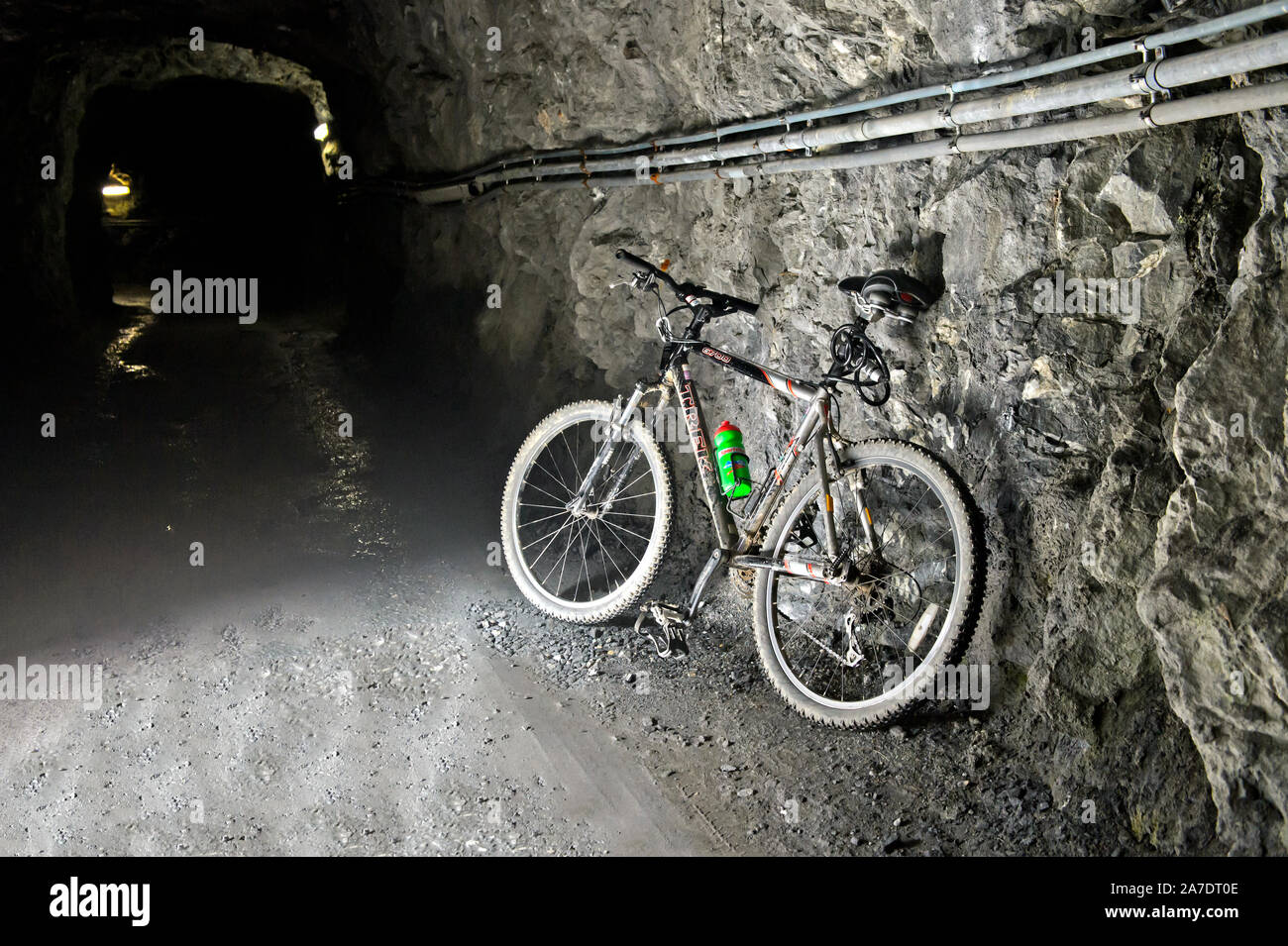 Mountain bike in a construction tunnel of the Mauvoisin water reservoir, Lac de Mauvoisin, Val de Bagnes, Valais, Switzerland Stock Photo
