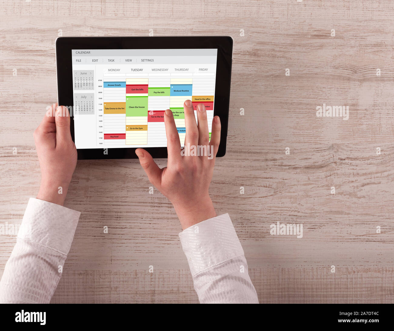 Hand holding tablet with timetable and calendar concept Stock Photo - Alamy