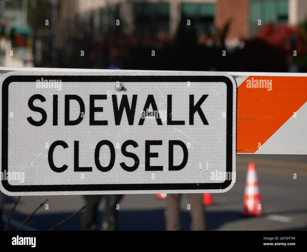 Orange and white sidewalk closed sign hi-res stock