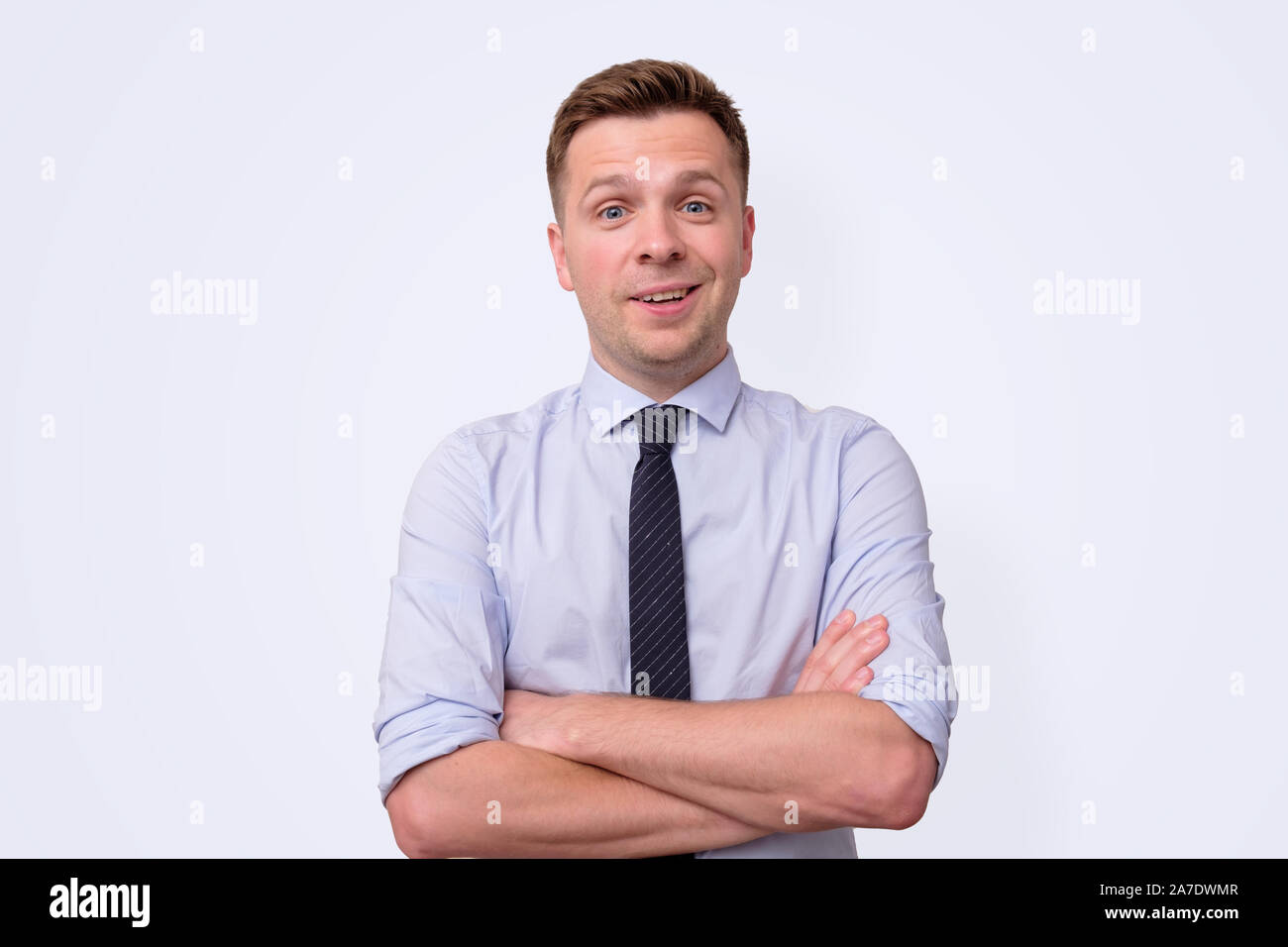 Handsome businessman with tie with folded hands. Studio shot Stock Photo