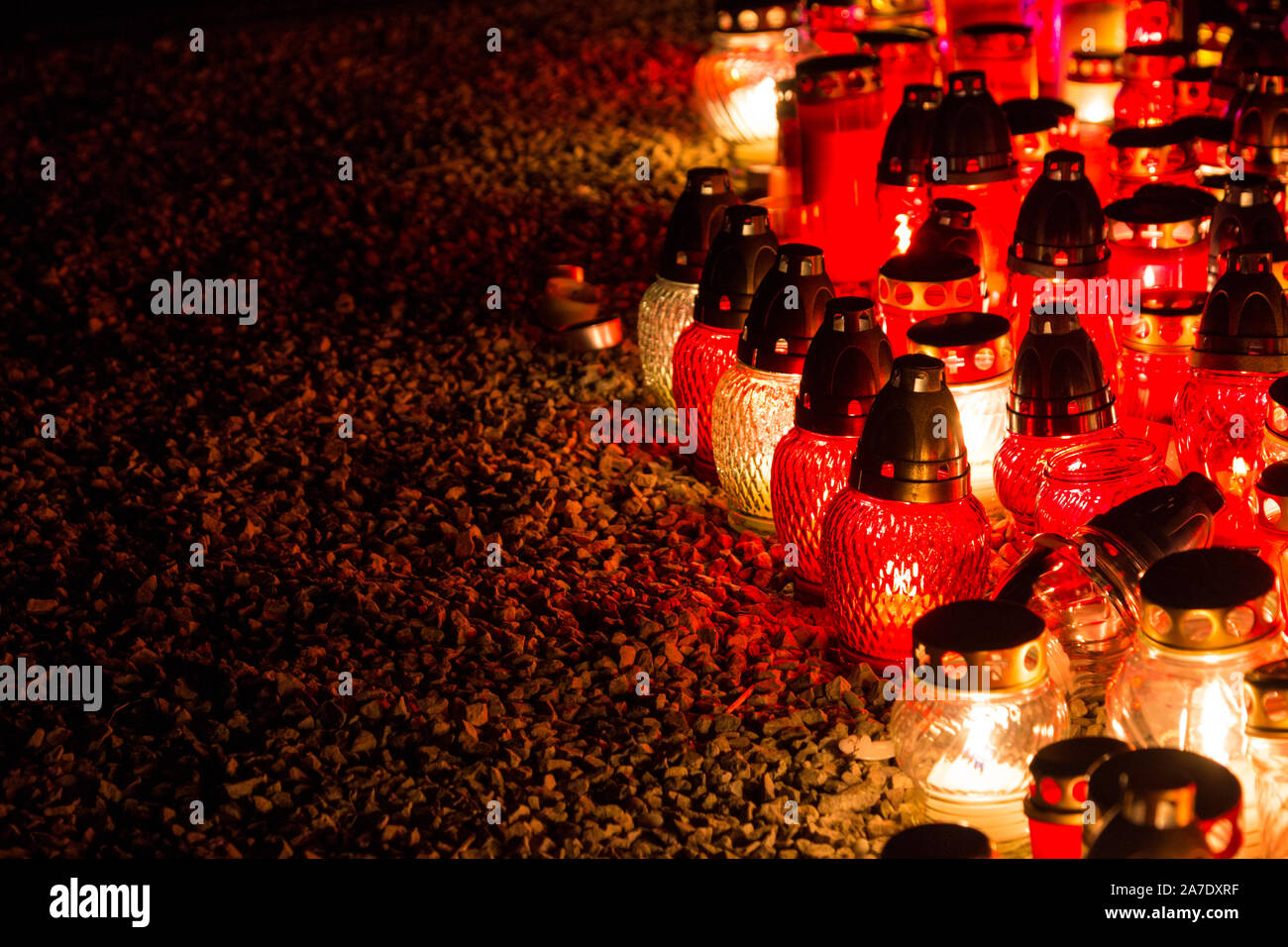 Candles burning beside Testverulet kereszt (Cross of Brotherhood) in the old Szent Mihaly temeto (St. Michael cemetery) on All Saints Day, Sopron, Hun Stock Photo
