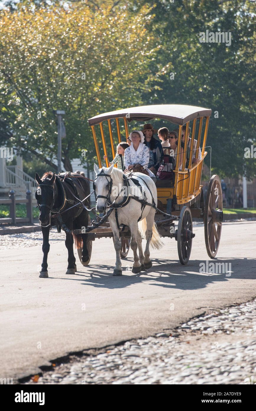 Colonial Williamsburg horse and carriage ride being enjoyed by visitors on a sunny day in