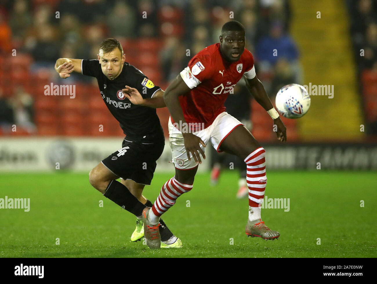 Bristol City's Andreas Weimann (left) and Barnsley's Dimitri Cavare battle for the ball during the Sky Bet Championship match at Oakwell, Barnsley. Stock Photo