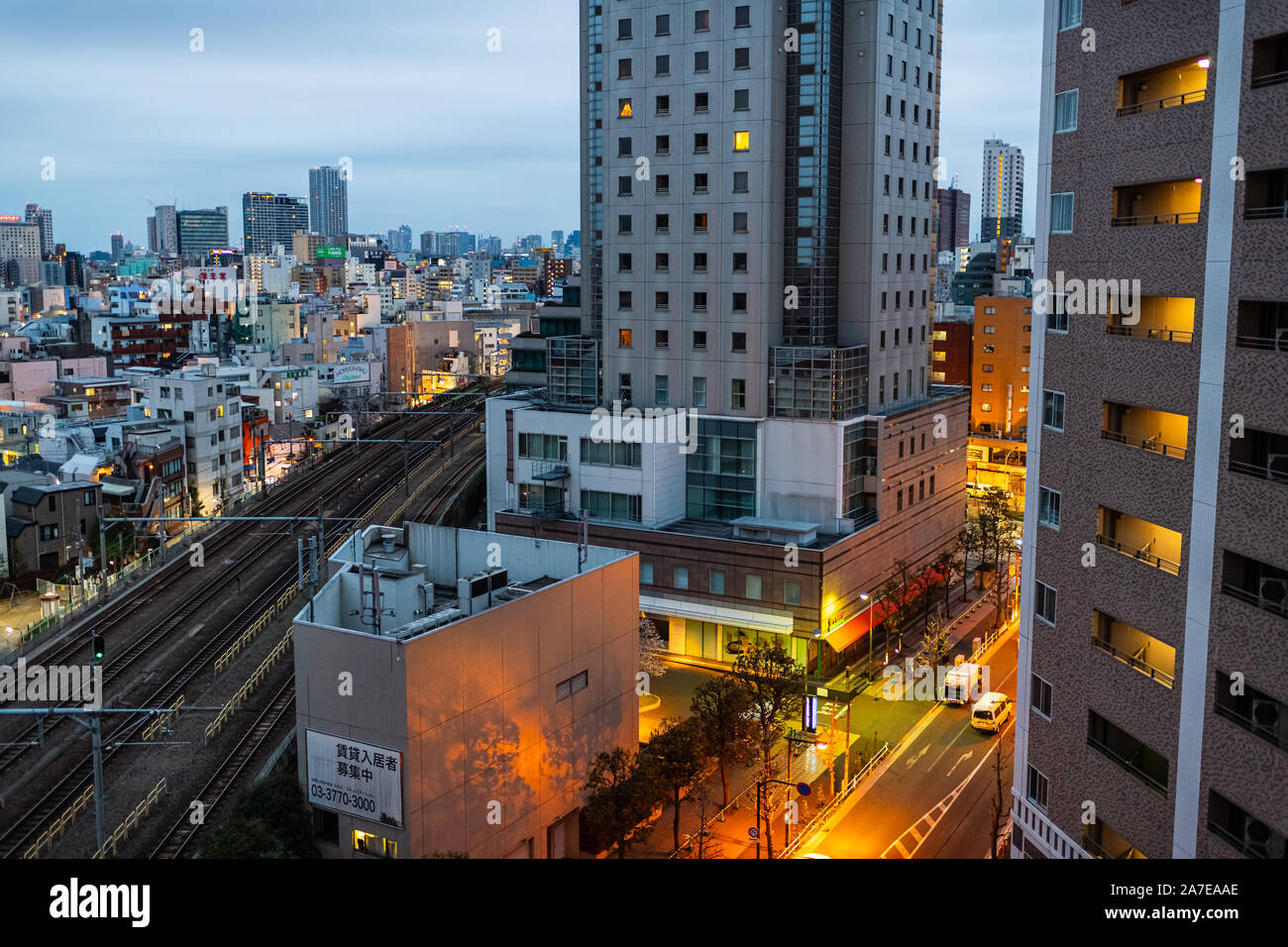 Tokyo, Japan - March 28, 2019: Shinjuku high angle bird's eye view of buildings residential area during dark night with illuminated street Stock Photo