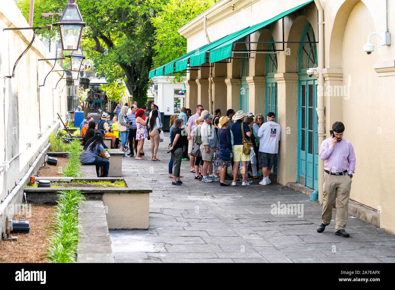 New Orleans, USA - April 23, 2018: People in line queue waiting to order food at Cafe Du Monde restaurant sign famous for beignet donuts and chicory c Stock Photo