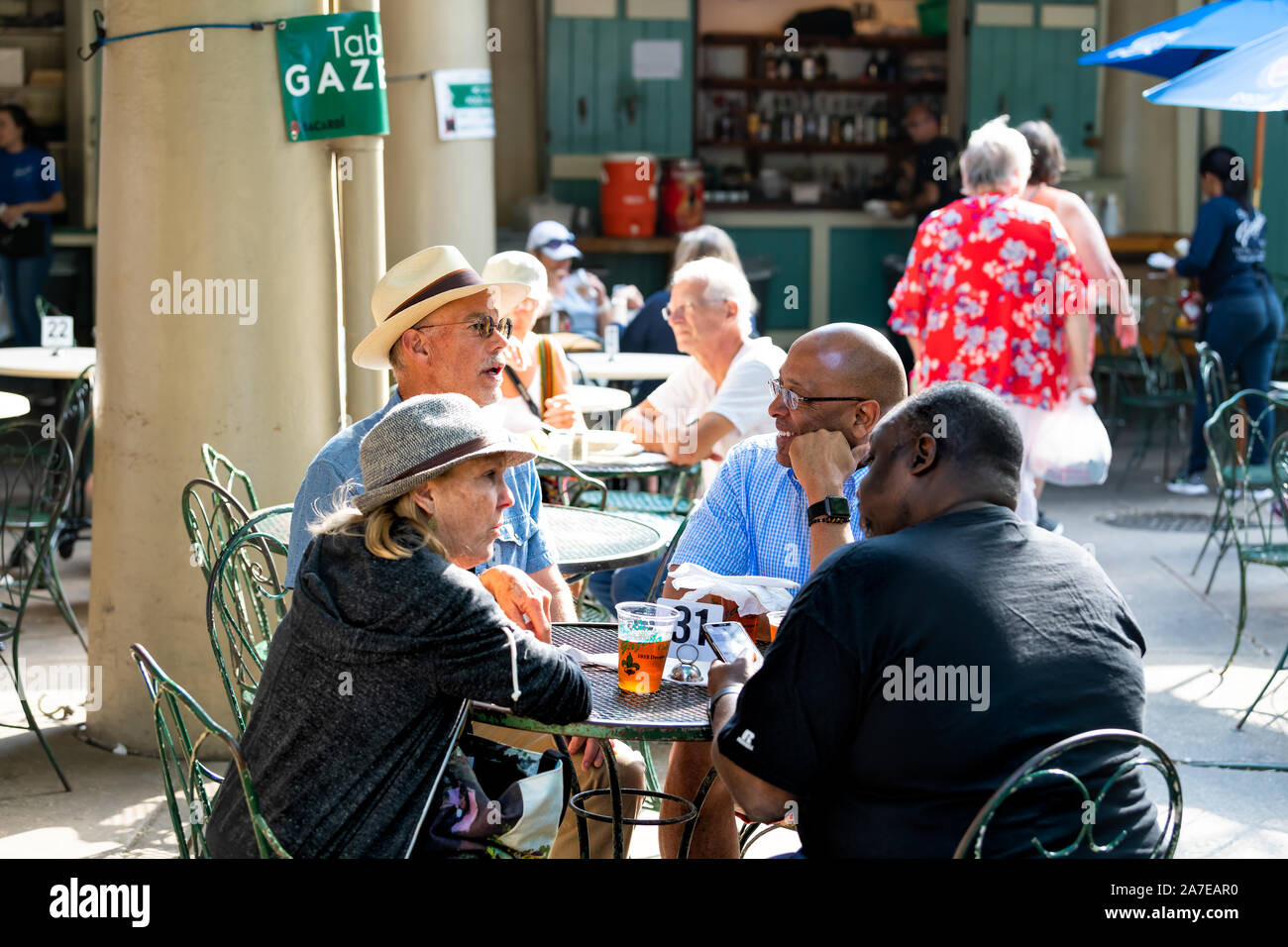 New Orleans, USA - April 23, 2018: People sitting eating cuisine food and beer at the Gazebo Cafe restaurant tables Stock Photo