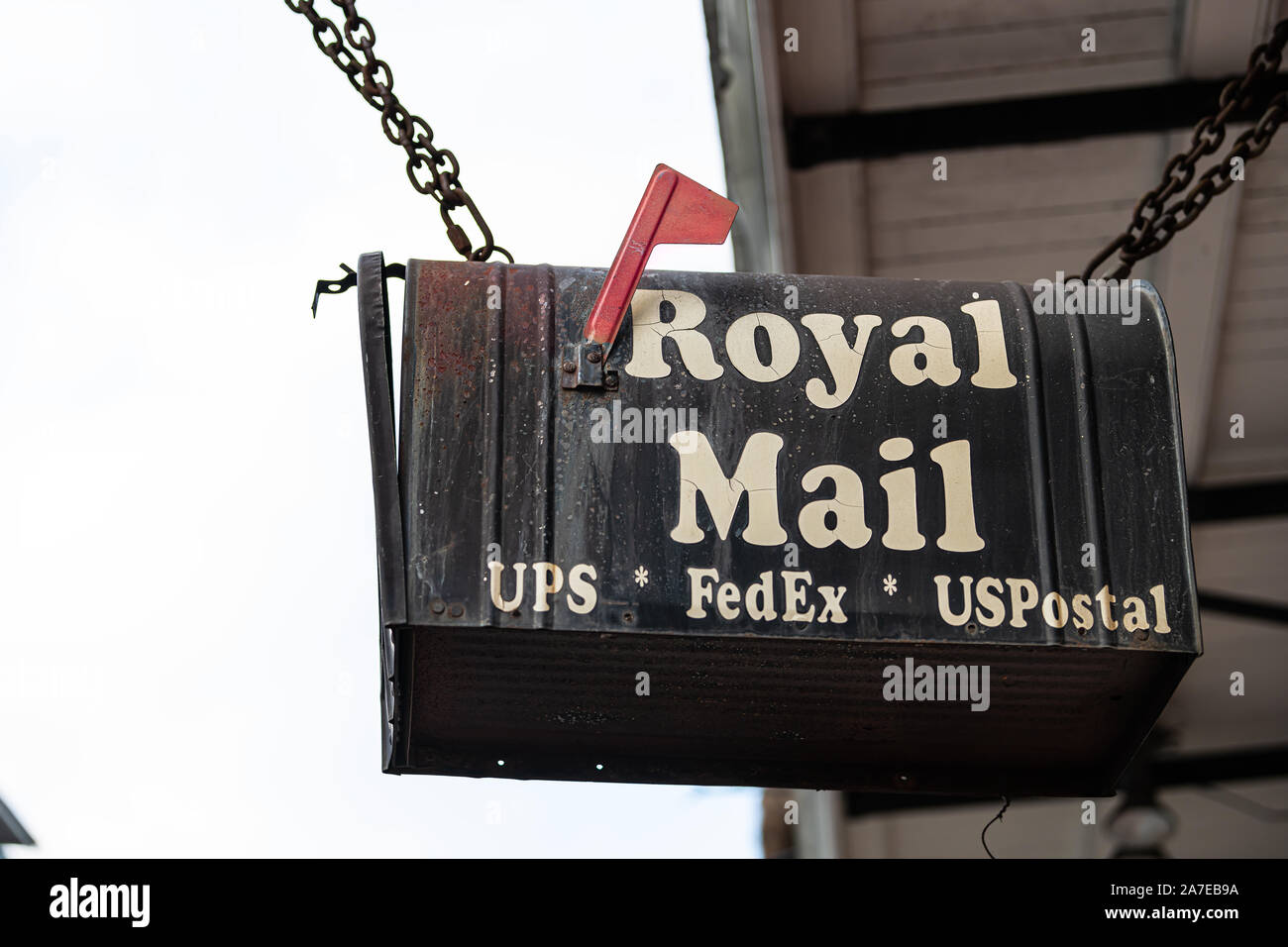 New Orleans, USA - April 23, 2018: Old town street in Louisiana city with closeup of sign for Royal Mail UPS FedEx and USPS Stock Photo