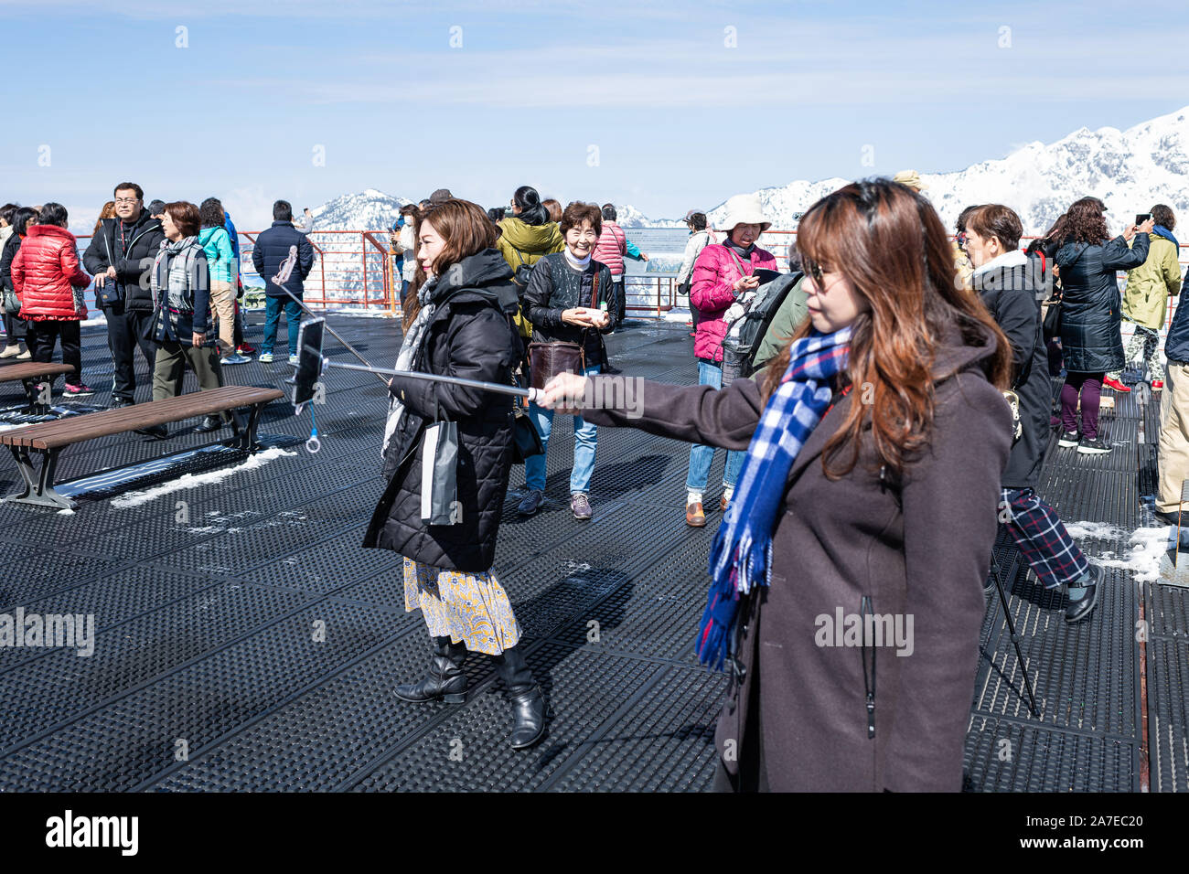 Takayama, Japan - April 8, 2019: Okuhida Shinhotaka Ropeway with tourists crowd and woman taking selfie in Gifu Prefecture park on spring day in mount Stock Photo