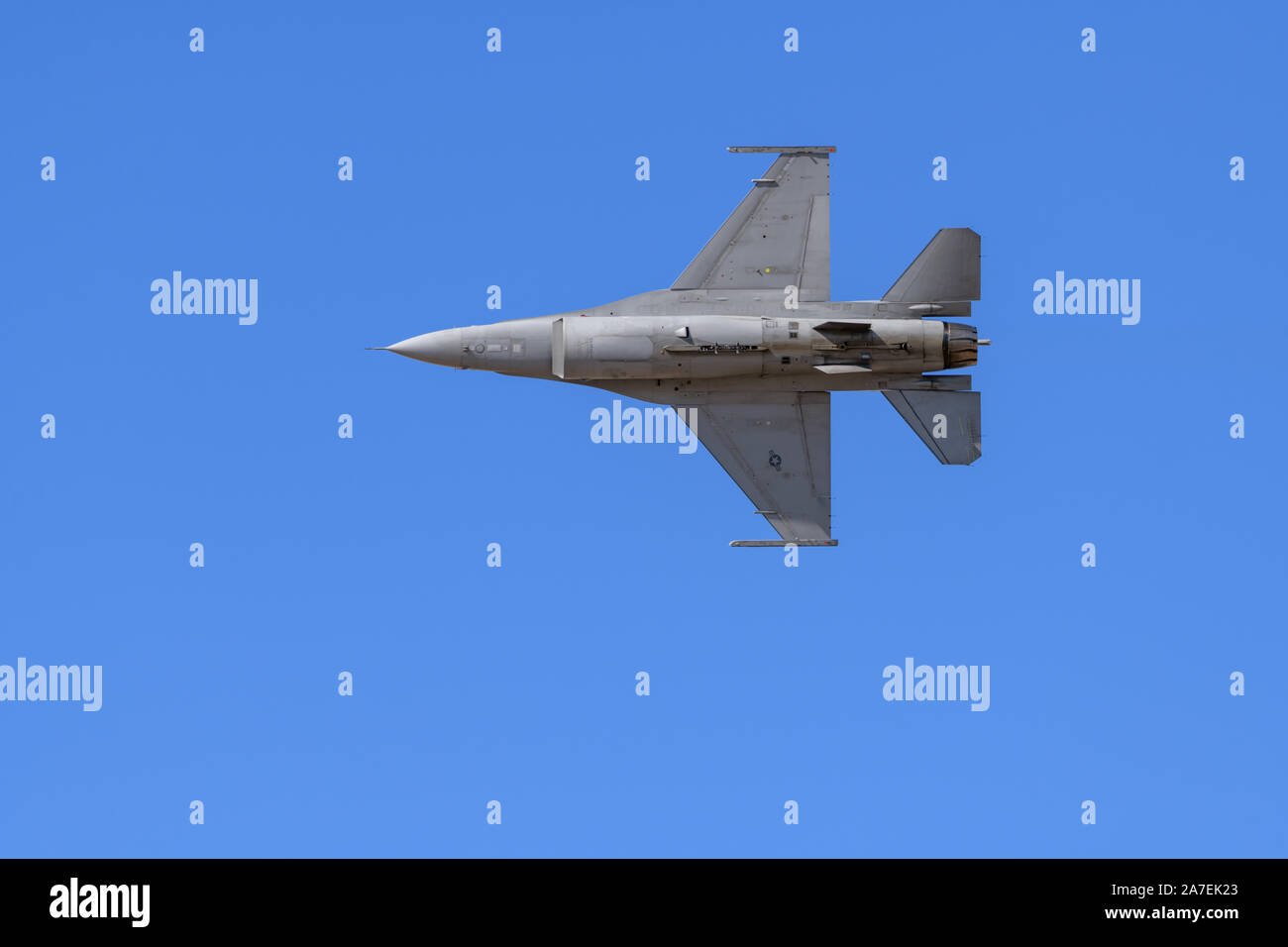 f-16V Viper Fighter Jet flying with clear blue sky in background Stock Photo