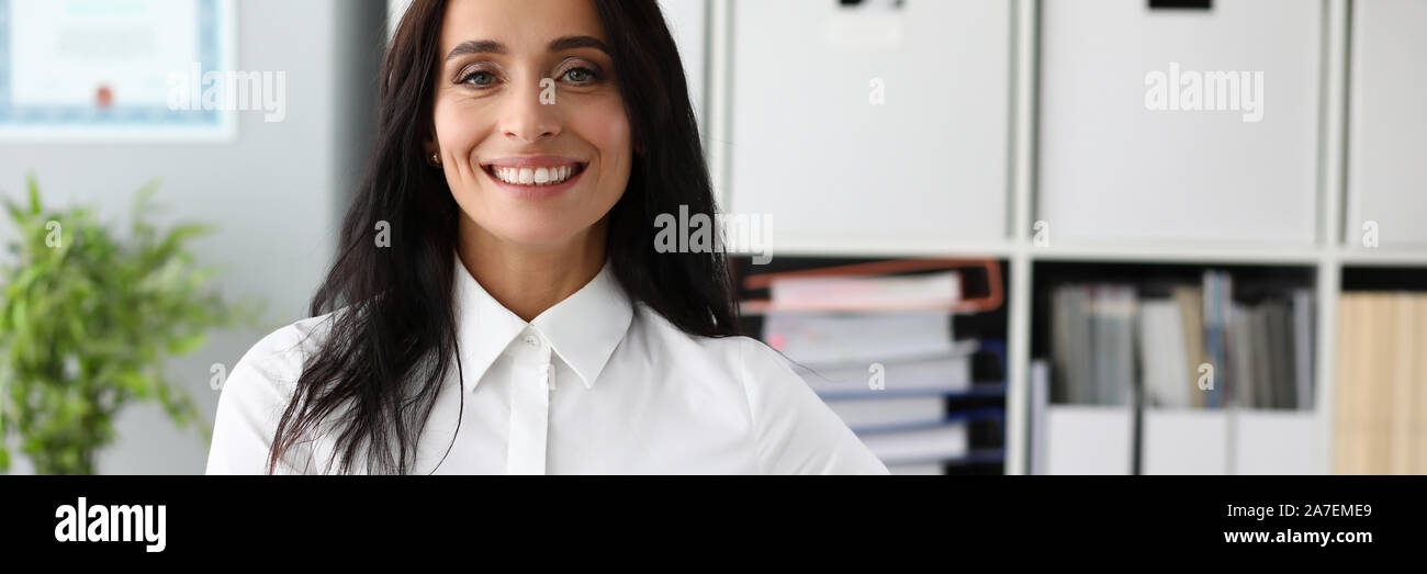 Business woman in white shirt against office Stock Photo - Alamy