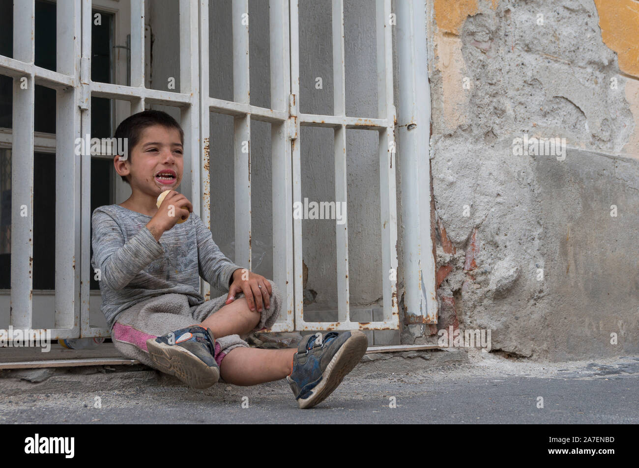 Poor sad little child eating ice cream on Children's Day Stock Photo