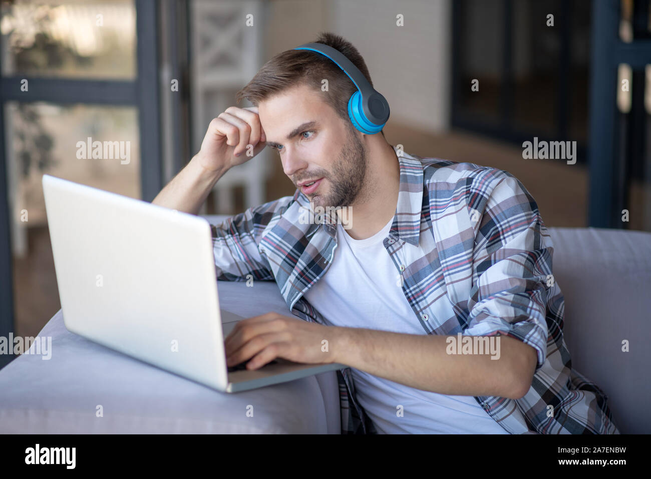 Bearded freelancer feeling overloaded having too much tasks Stock Photo