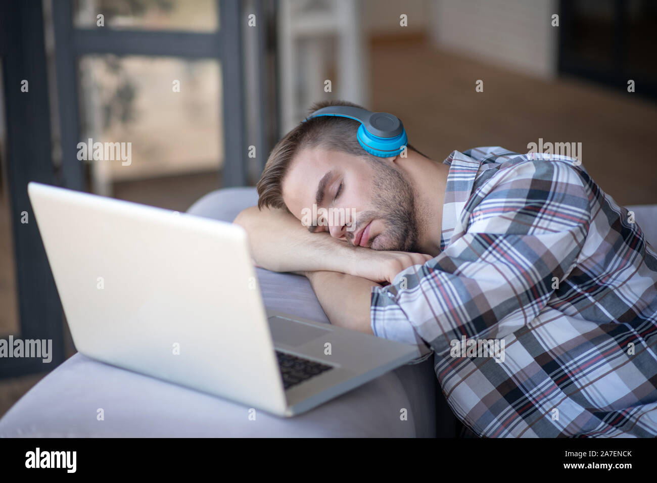 Bearded freelancer falling asleep after working for too long Stock Photo
