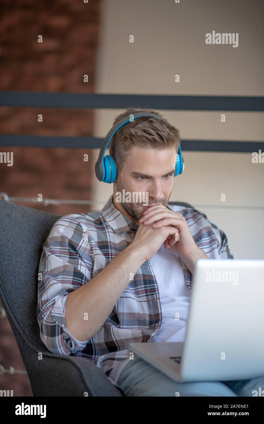 Young freelancer feeling concerned while having deadline Stock Photo