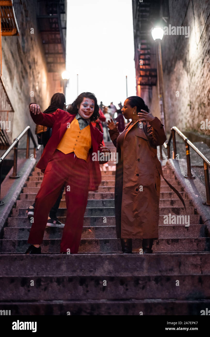 NEW YORK, USA,-NOVEMBER 31,2019: Random people impersonating the Joker and dancing at staircase in the Bronx, New York Stock Photo