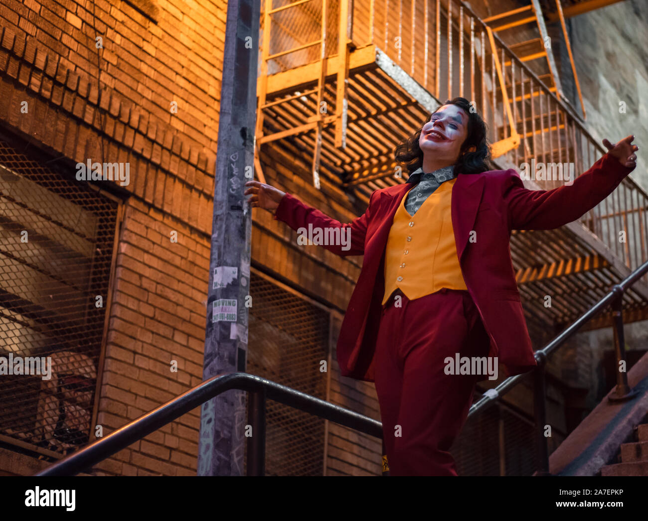 NEW YORK, USA,-NOVEMBER 31,2019: Random person impersonating the Joker and dancing at staircase in the Bronx, New York Stock Photo