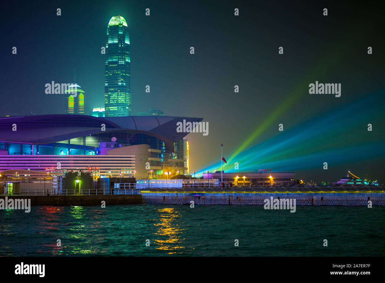 The Hong Kong Convention Center along Hong Kong harbour with celebratory searchlights prior to the New Years fireworks. Stock Photo